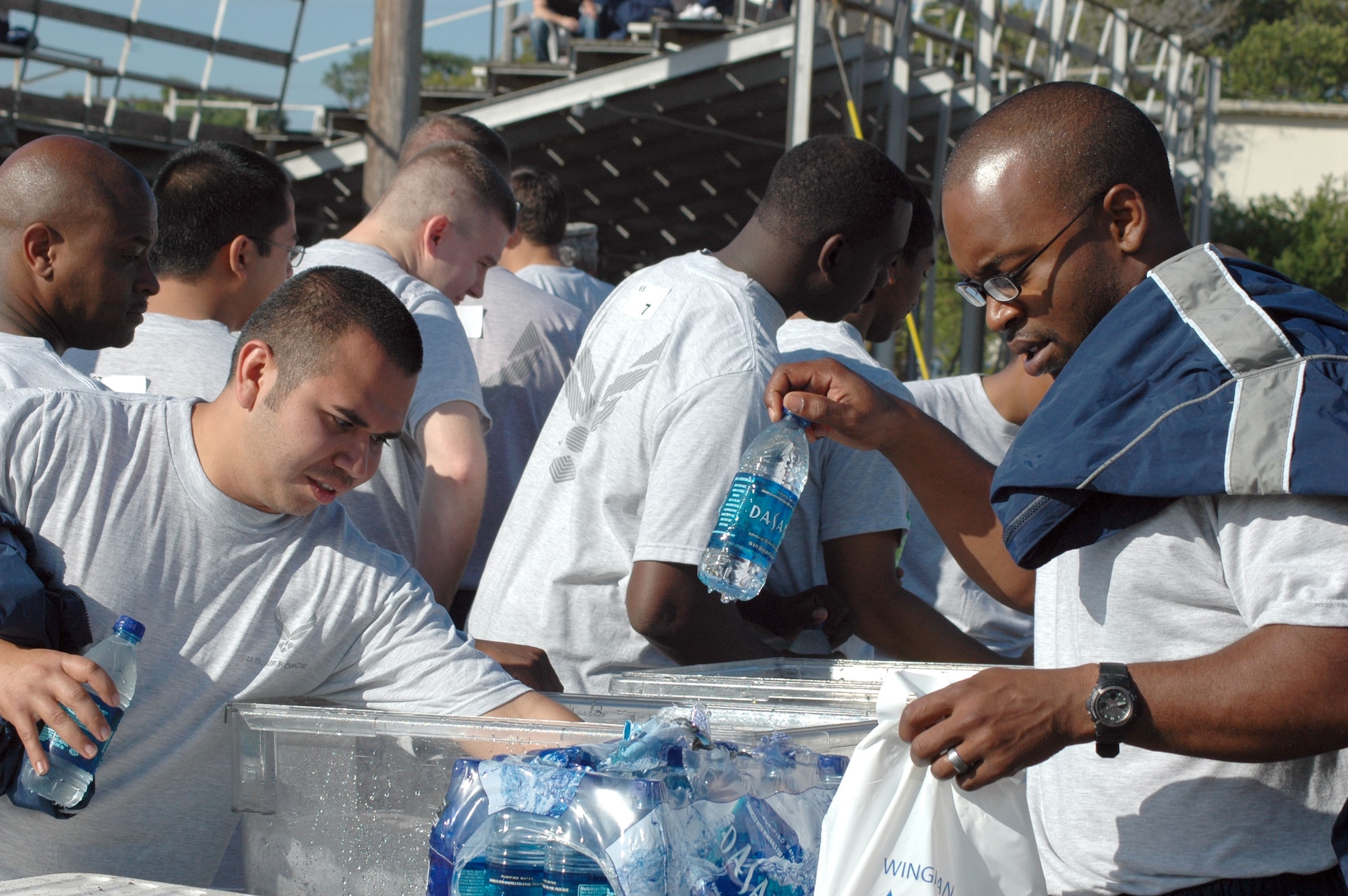 EGLIN AIR FORCE BASE, Fla. -- Airmen participating the Wingman Day activities at Foster Stadium grab some water for their teammates to keep properly hydrated. Wingman Day is a day of teambuilding exercises and other events aimed at fostering the Wingman concept of looking out for fellow Airmen. (U.S. Air Force photo/Staff Sgt. Stacia Zachary)