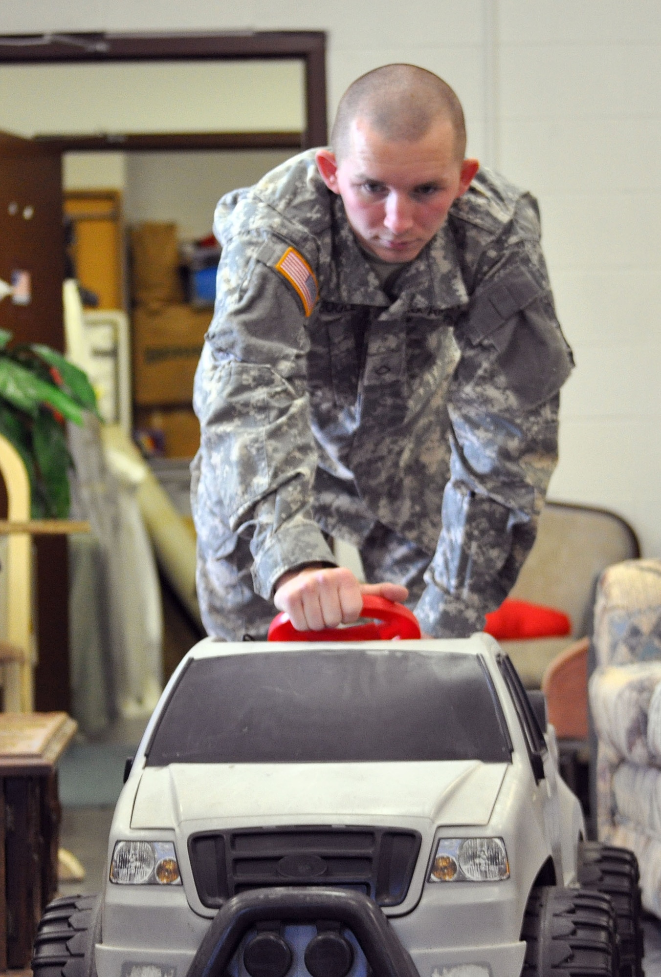 EGLIN AIR FORCE BASE, Fla. -- Pfc. Brandon Bogle, a Soldier in advanced individual training at the Explosive Ordnance School here, collects donations at the Airman's Attic and helps redistribute them within the store. (U.S. Air Force photo/Airman Chris Jacobs)
