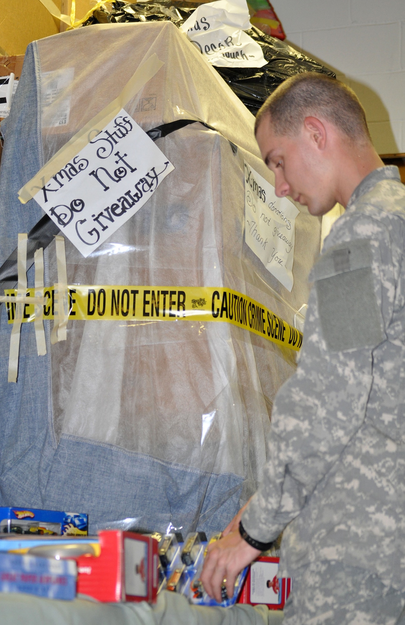 EGLIN AIR FORCE BASE, Fla. -- Pvt. Brian Saul, a Soldier in advanced individual training at the Explosive Ordnance School here, collects donations at the Airman's Attic and helps redistribute them within the store. (U.S. Air Force photo/Airman Chris Jacobs)