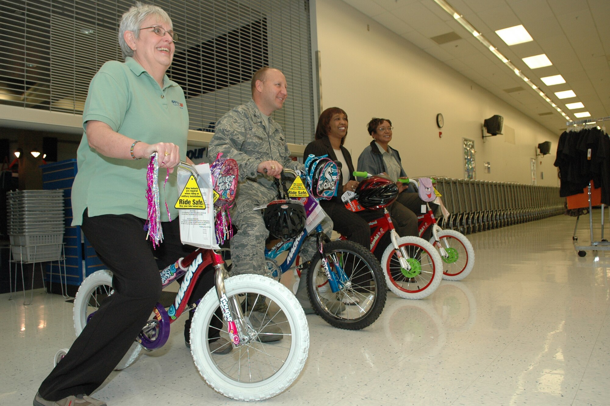 From left: Tinker exchange main store manager Catherine Jones, Oklahoma City Air Logistics Center’s Col. Tracy Tynan, exchange Human Resources Manager Sherilyn Benjamin and Base Exchange general manager Bettye Golston participate in a training wheels-only race in the Base Exchange Oct. 30 to help raise money for agencies tied to the Combined Federal Campaign, which runs through Nov. 14 and Tinker is on track to meet the goal of $1.65 million. “It’s great that we could all come out and support this. It’s a worthy cause. The exchange is an organization that helps Tinker reach for it’s CFC goals, year in and year out,” said Colonel Tynan, an organizer for the CFC this year. (Air Force photo)