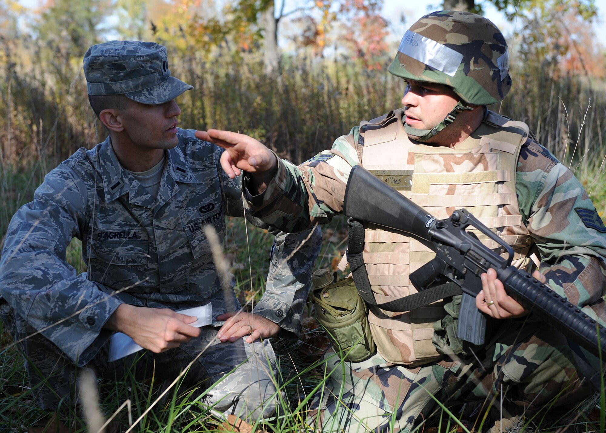 SCOTT AIR FORCE BASE, Ill. -- Staff Sgt. Tim Milnes, 375th Civil Engineer Squadron, talks over his plan for advancement with 2nd Lt. Sly d’Agrella, 375th CES, during their field training exercise Thursday. Members of 375th CES worked together to get through many obstacles such as a sniper attack, ambushes and an improvised explosive device alley. (U.S. Air Force photo/Airman 1st Class Wesley Farnsworth) 