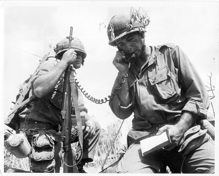 Private First Class Larry Smith, left, with his platoon leader, Lt. Ward, calling in an artillery fire. Private Smith became a war-seasoned military man on only his second day in Vietnam. When an ambush turned a routine patrol into a blaze of bullets and explosions, the young Marine looked to the platoon sergeant who had promised to guide him, only to see him killed.  Private Smith would survive the war with two Purple Hearts, even though medical personnel frantically working on him after a mine explosion pronounced he would die from his wounds.