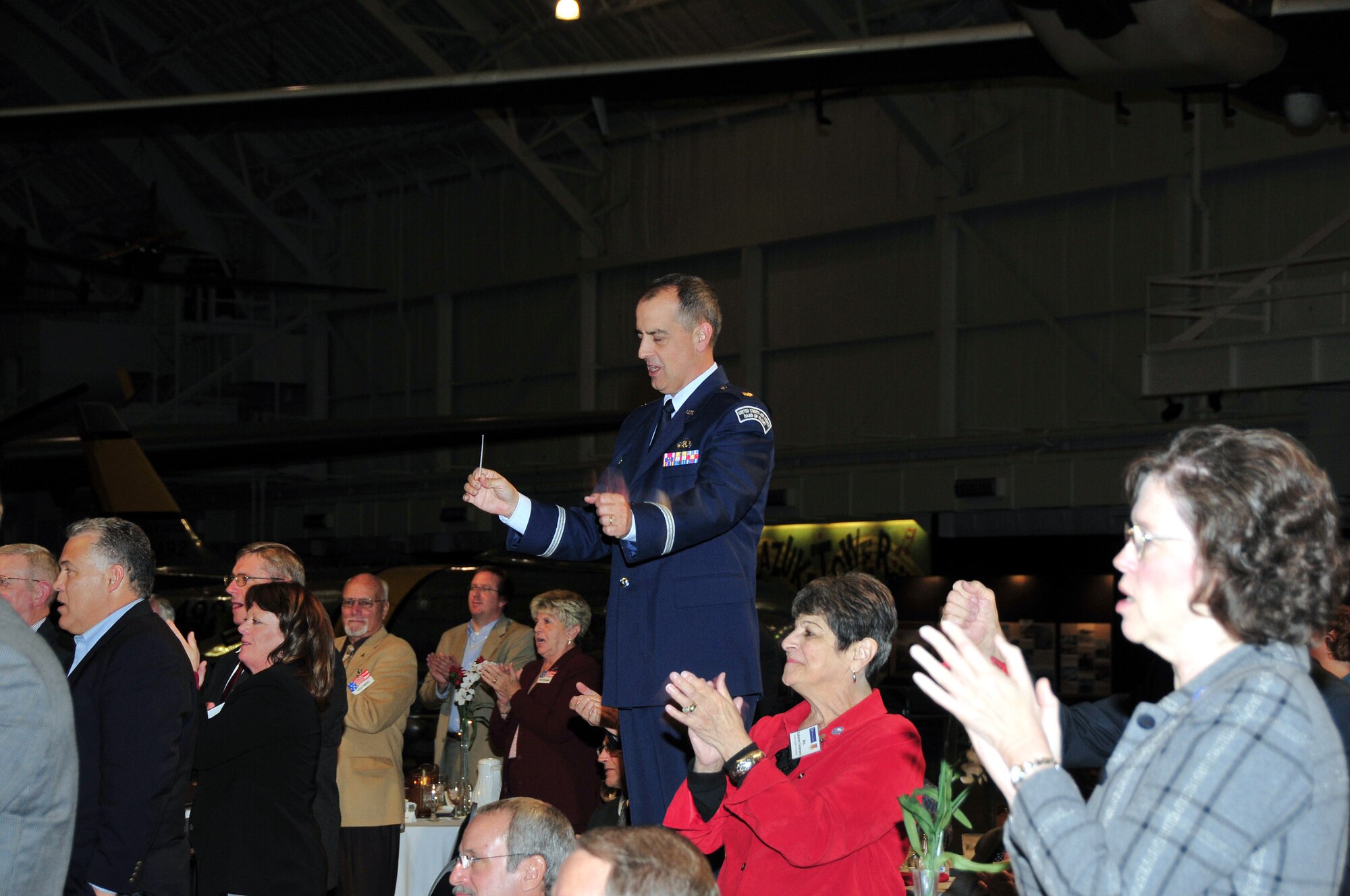 WRIGHT-PATTERSON AFB, Ohio - The 445th Airlift Wing hosted a group of civic leaders from the Barksdale AFB, La. area Oct. 29-30, 2008.  The tour included a dinner at the National Museum of the U.S. Air Force with a performance by the Air Force Band of Flight.  Band of Flight director Maj. Richard Mensch, directs the band performance from the center of the dining space. (Courtesy photo/Bill Richard)