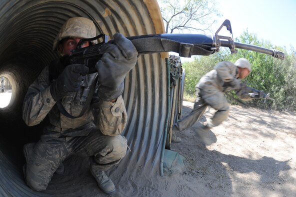 A basic trainee provides defensive cover during the tactical assault course Oct. 29 at Lackland Air Force Base, Texas. The tactical assault course tests their defensive tactics and communication skills. (U.S. Air Force photo/Staff Sgt. Desiree N. Palacios)
