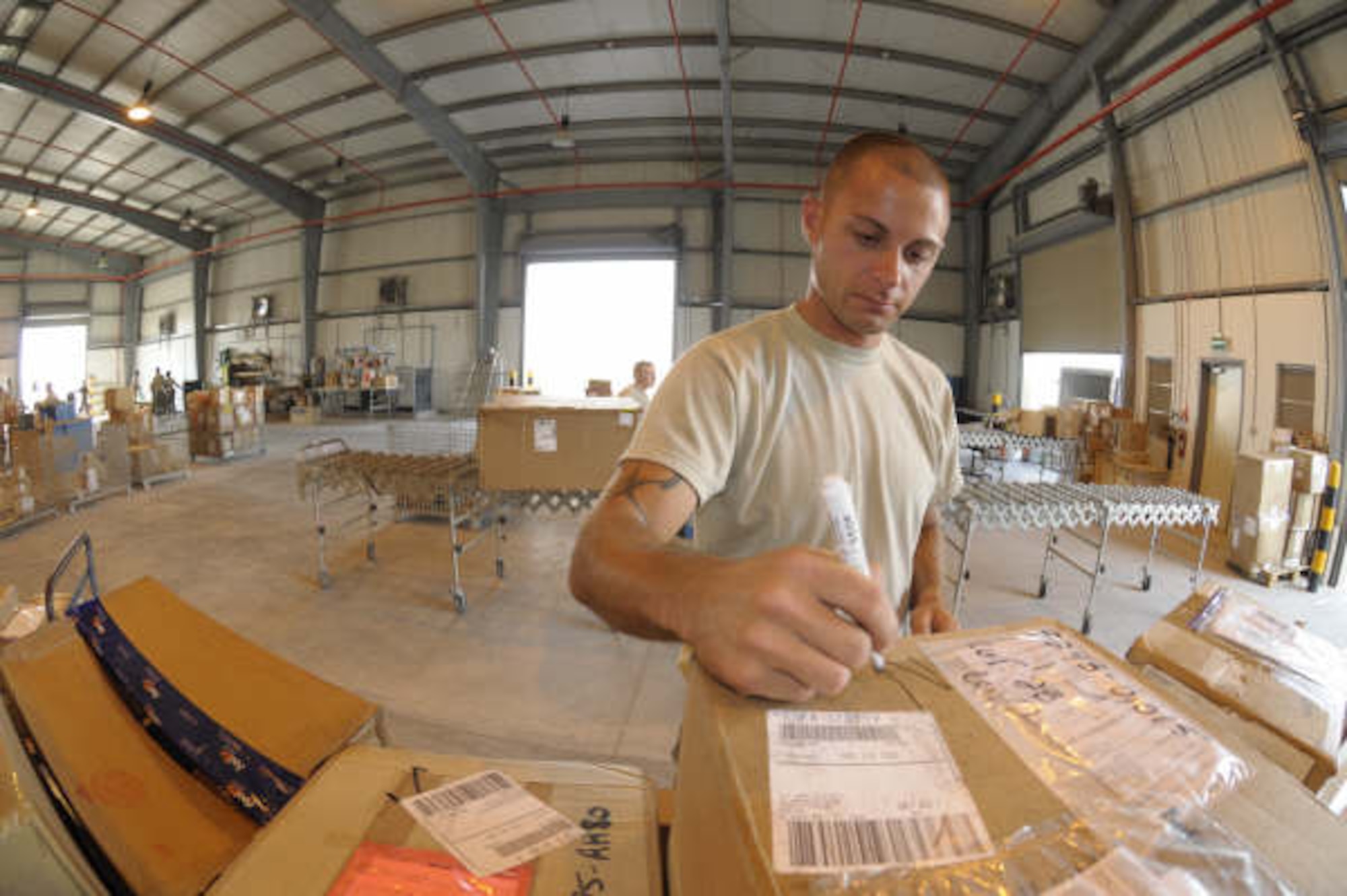 HANSCOM AIR FORCE BASE, Mass. – Staff Sgt. Andrey Senchykov works to process incoming and outgoing packages for the 379th Expeditionary Logistics Readiness Squadron that provides support for the Global War on Terrorism in Operations Iraqi Freedom, Enduring Freedom and through support of the Joint Task Force Horn of Africa. Sergeant Senchykov is deployed from Hanscom Air Force Base where he serves as the noncommissioned officer in charge of customer support for the Joint Personnel Property Shipping Office. (U.S. Air Force photo by Mark Wyatt)