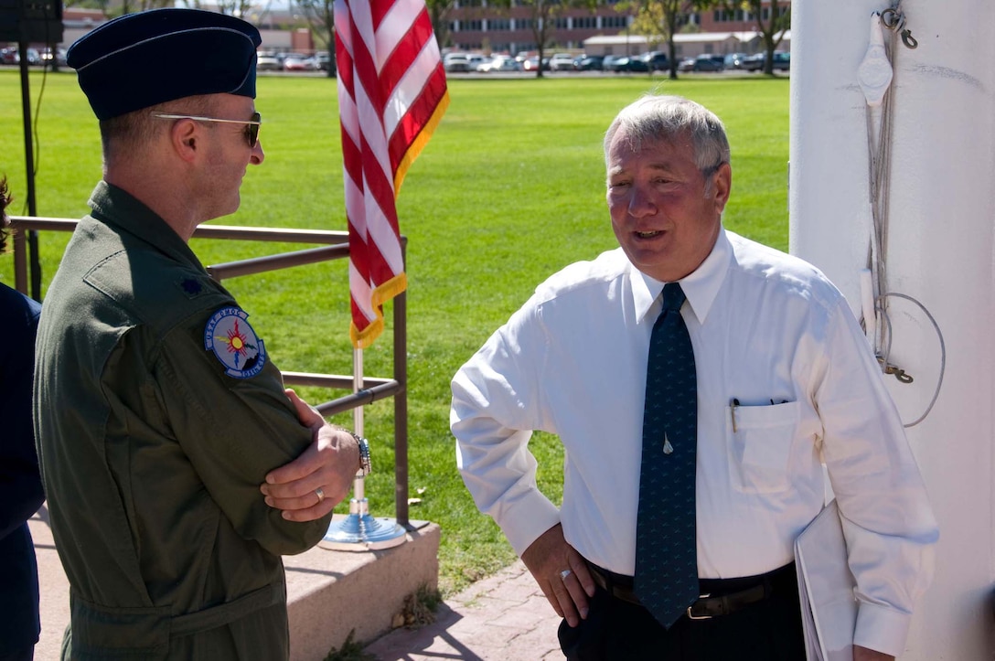 Col. Robert Hudson, right, speaks with an Air Force Operational Test and Evaluation Center member following his speech at the September 2008 opening ceremony for the annual POW/MIA 24-hour run at Kirtland AFB, N.M.