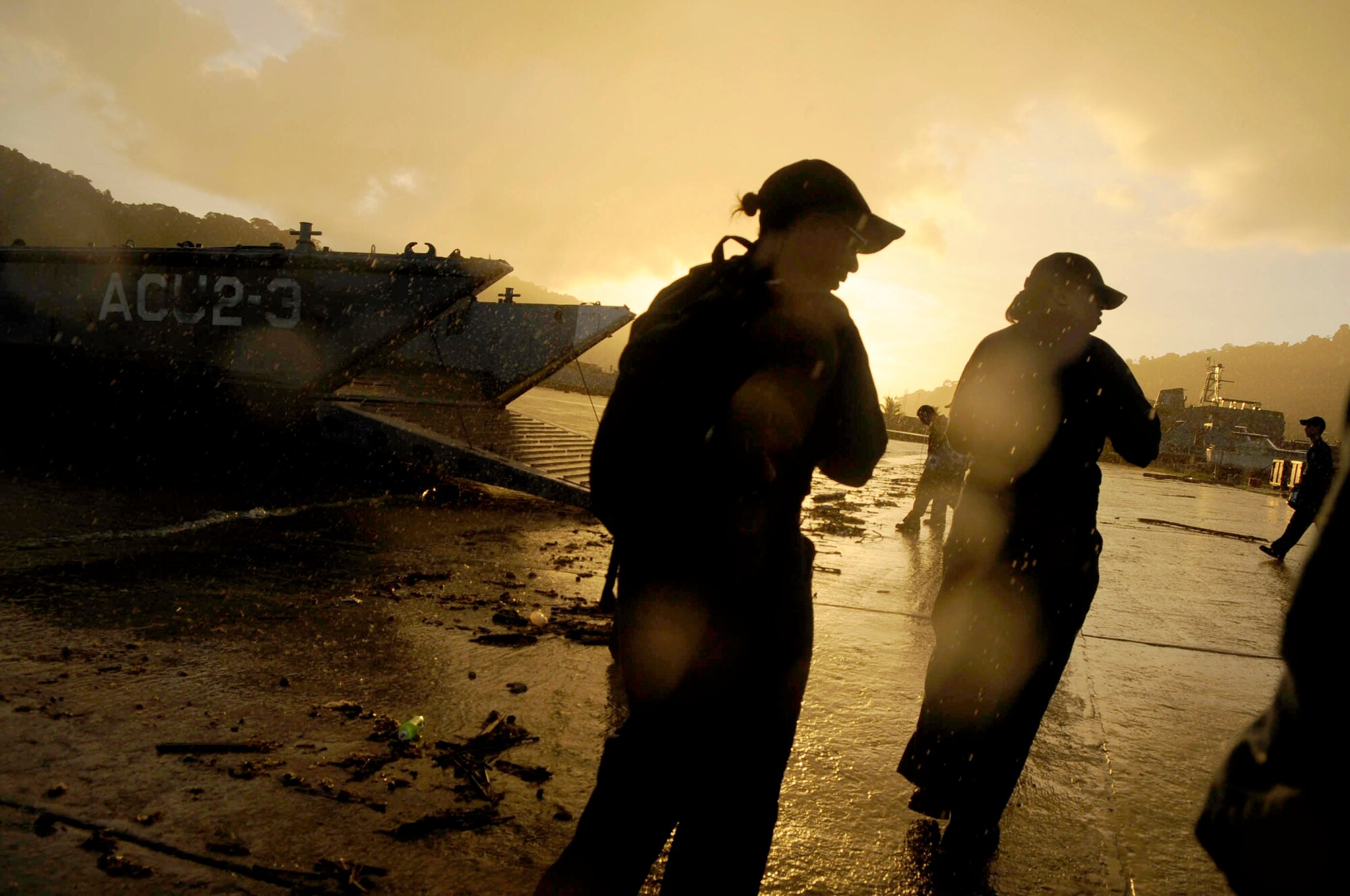 Sailors board a landing craft after completing a 14-hour day building fences and a playground at the All-in-One Development Center in support of Operation Continuing Promise 2008 Nov. 4 in Tunapuna, Trinidad and Tobago. (U.S. Air Force photo/Master Sgt. Cecilio Ricardo) 