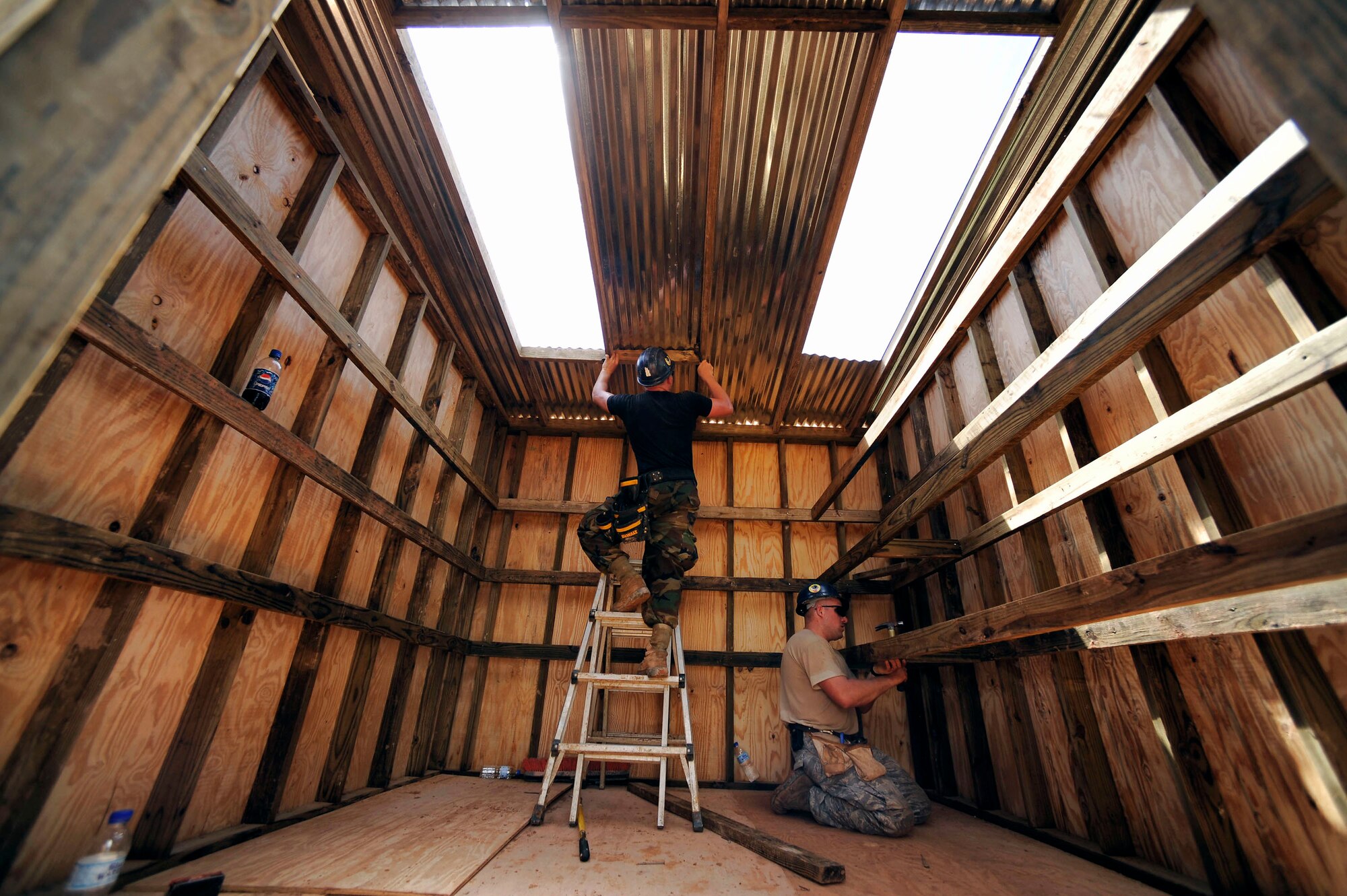 Airman Daniel Pauls and Staff Sgt. Bruce Hills build a shed for the All-in-One Development Center in support of Operation Continuing Promise 2008 Nov. 4 in Tunapuna, Trinidad and Tobago. Airman Pauls and Sergeant Hills are part of the Prime BEEF contingency group from Minot Air Force Base, N.D. (U.S. Air Force photo/Master Sgt. Cecilio Ricardo)