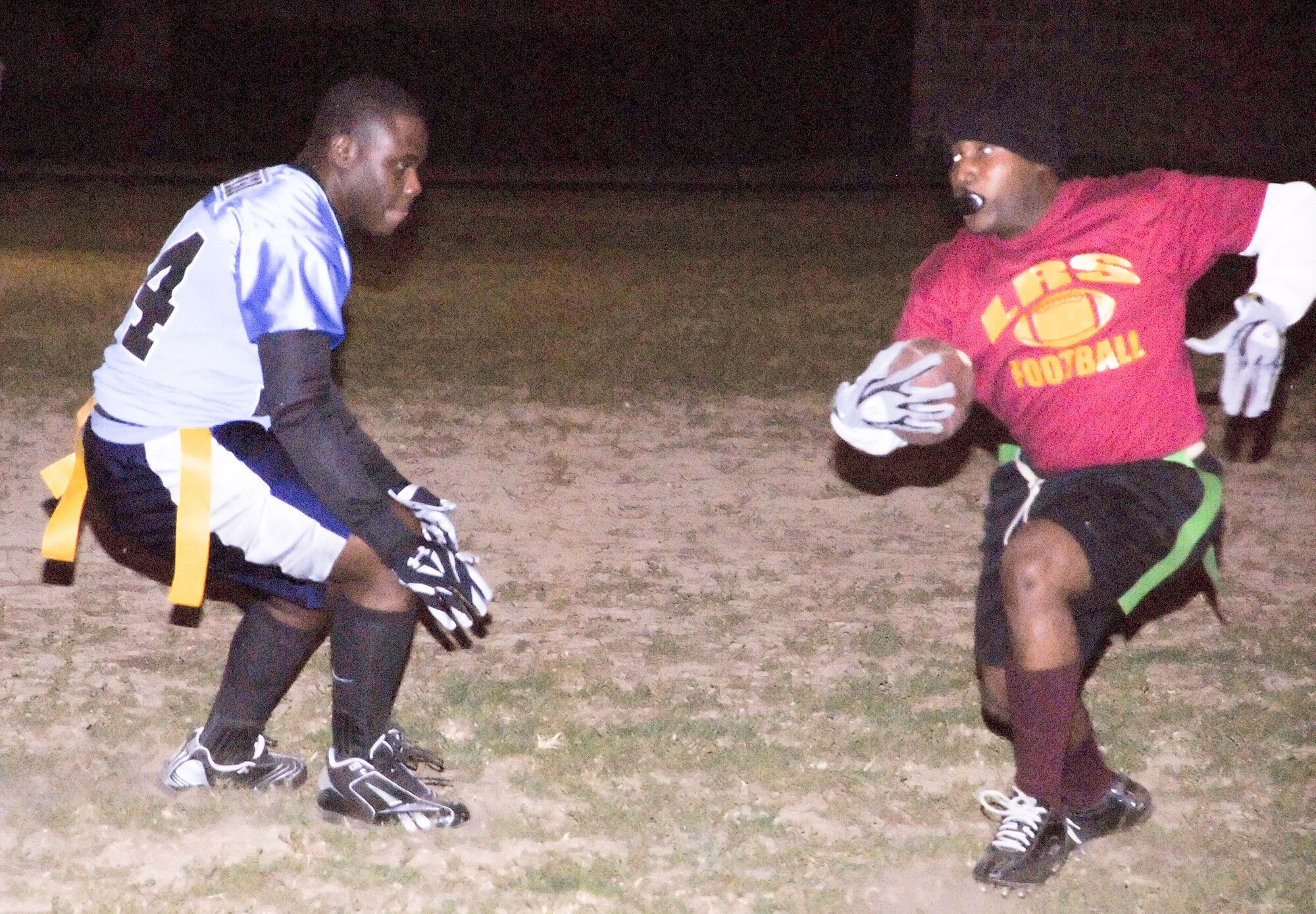 (Right) Deok Kim, LRS wide receiver, tries to get past the MXS defense in the first half of their game Nov. 3.  MXS defeated LRS 13-12.  (U.S. Air Force photo/Staff Sgt. Chad Padgett)