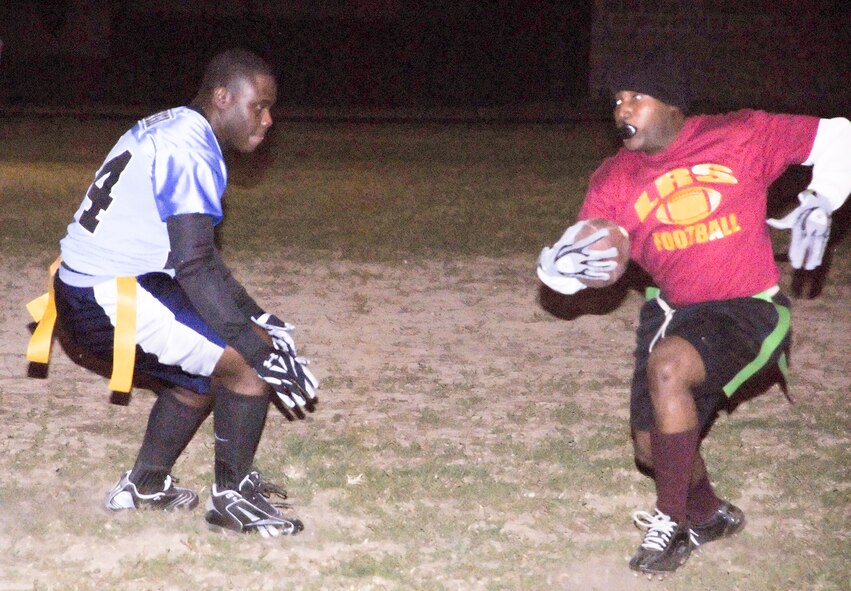 (Right) Deok Kim, LRS wide receiver, tries to get past the MXS defense in the first half of their game Nov. 3.  MXS defeated LRS 13-12.  (U.S. Air Force photo/Staff Sgt. Chad Padgett)