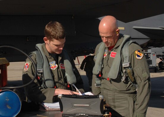 Captain Kenneth Madsen from the 333rd Fighter Squadron briefs bassmaster pro-angler Marty Stone on the flight plans before his orientation flight, here at Seymour Johnson Air Force Base, N.C., Oct. 29. Mr. Stone toured the base prior to receiving an orientation flight because of his abilities to communicate the 4th  Fighter Wing and United States Air Force mission to worldwide audiences.(US Air Force photo By Airman First Class Gino Reyes)(Released)