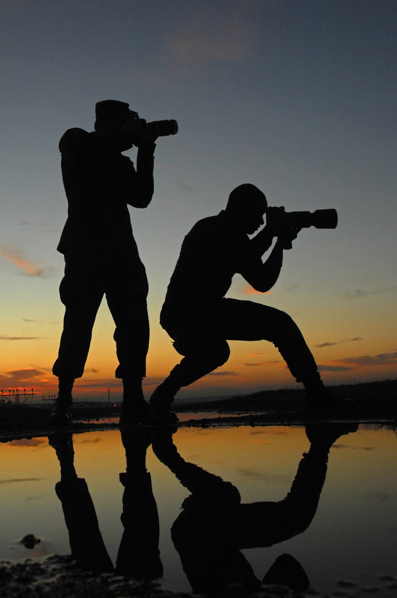 Airman 1st Class Tony Ritter and Airman 1st Class Kenny Holston capture images of incoming aircraft Nov. 3 at Ramstein Air Base, Germany. Airmen Ritter and Holston are 435th Air Base Wing public affairs photographers. (U.S. Air Force/Airman 1st Class Kenny Holston)
