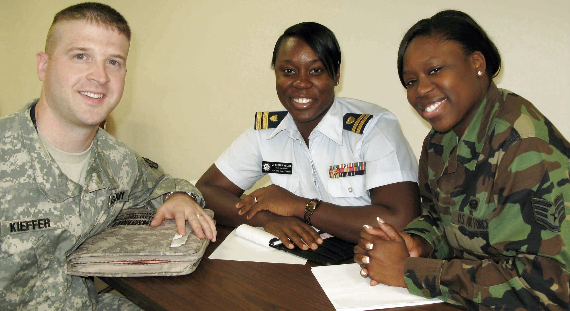 Armed Forces Inaugural Committee members Army Capt. Sam Kieffer, Coast Guard Lt. Kishia Mills and Staff Sgt. Olayinka Olatunji prepare to issue building and other credentials to the new AFIC members Nov. 5 in Washington, D.C. (Defense Department photo/Gerry J. Gilmore)