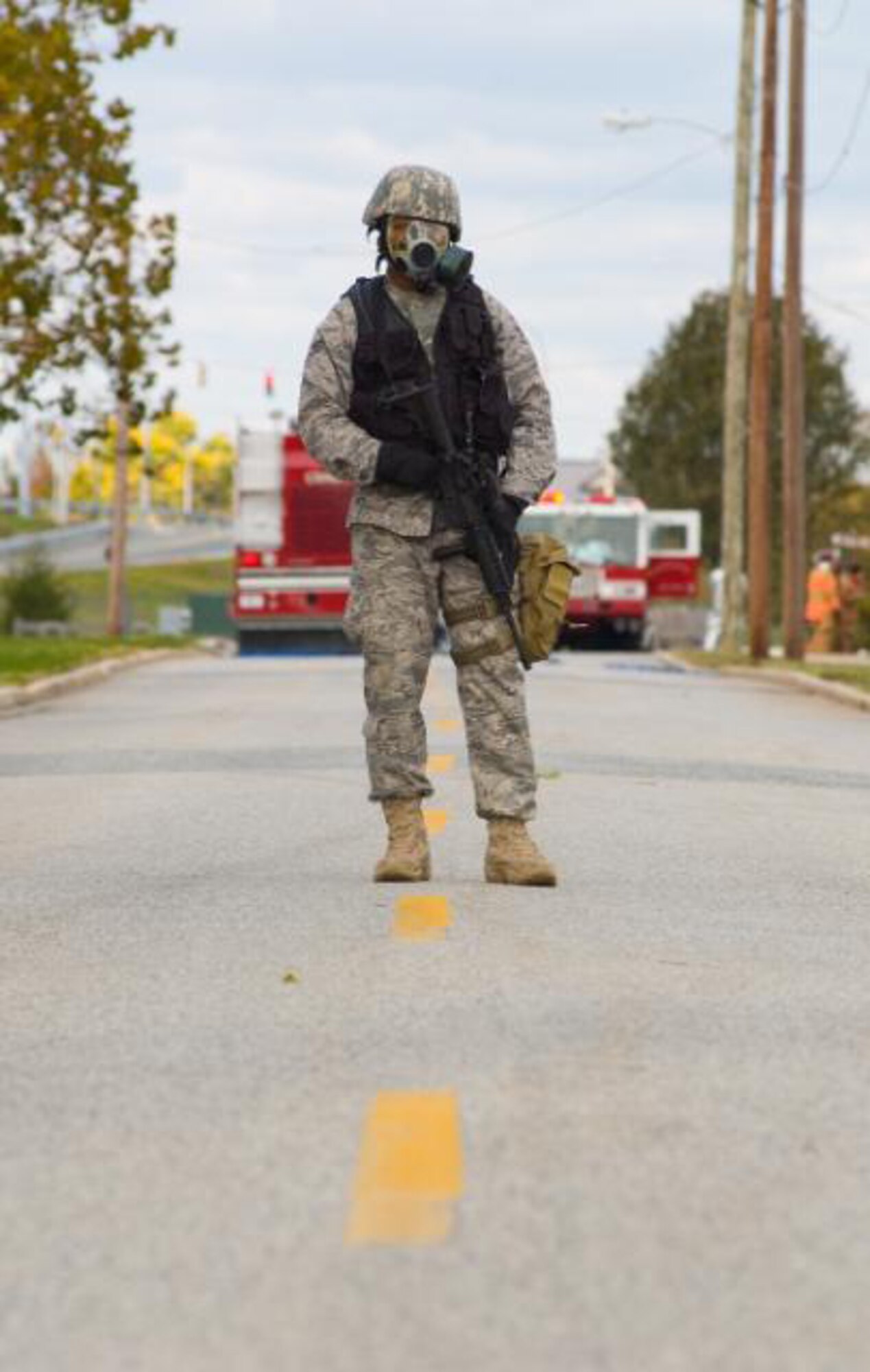 A Team Dover Airman stands guard along the perimeter of an exercise incident during the Major Accident Response Exercise Oct. 29.   (U.S. Air Force photo/Roland Balik)