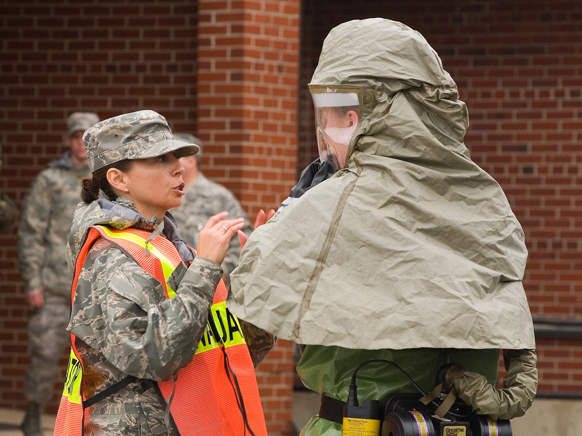 (Left) Tech. Sgt. Mimi Kramer, 436th Medical Support Squadron, advises an in-place patient decon team member during the Major Accident Response Exercise Oct. 28.  Sergeant Kramer worked as an evaluator during the exercise.  (U.S. Air Force photo/Thomas Randle)   