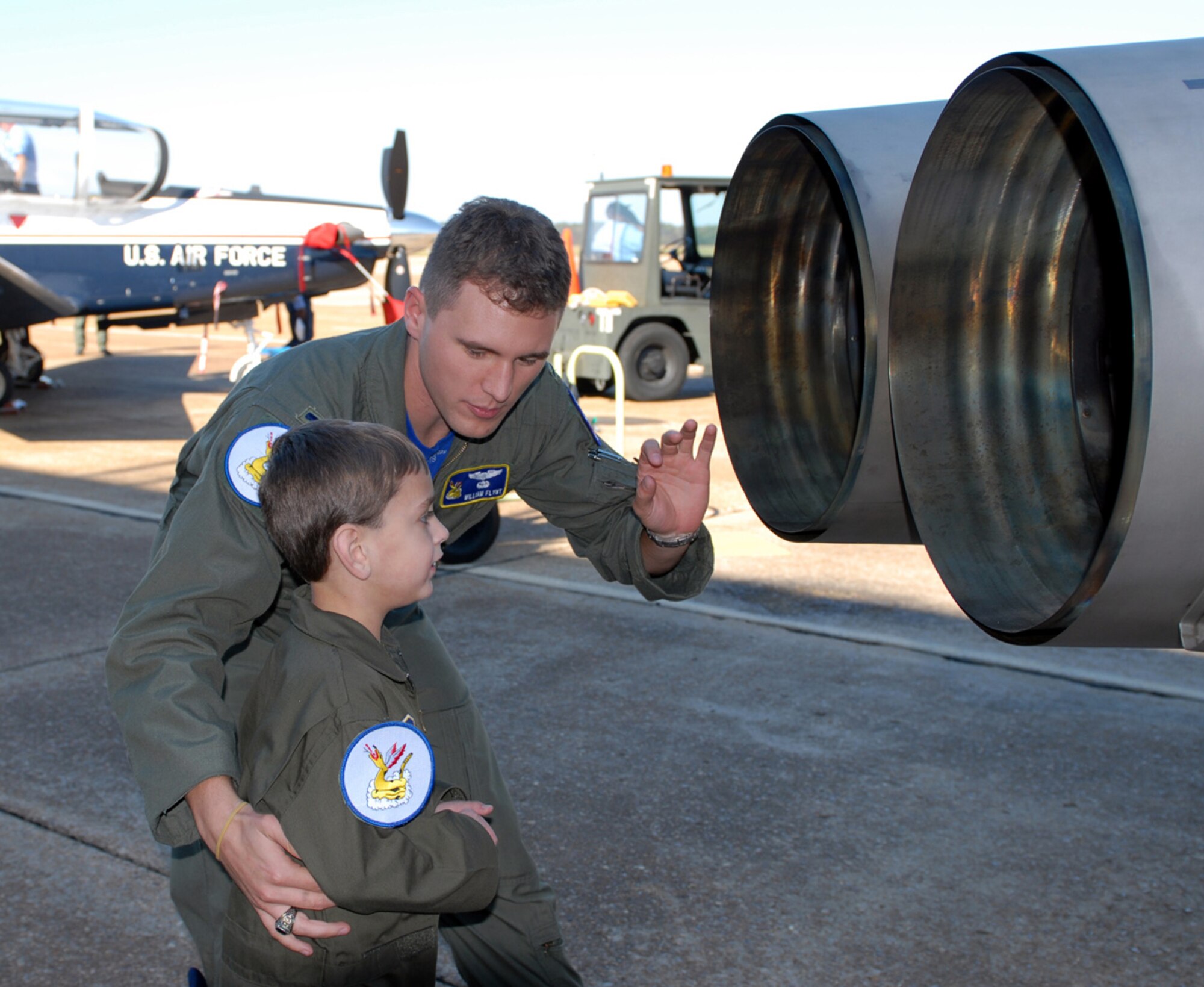 First Lt. Will Flynt, 50th Flying Training Squadron, explains to Columbus AFB Pilot for a Day Noah Hutchinson the details of the T-38 nozzle Oct. 31.  Lieutenant Flynt was the project officer who worked diligently for several months to make Noah’s dream of visiting an Air Force base a reality. Noah, from St. Joseph, Mo., was born with the use of only the right side of his heart. (U.S. Air Force photo by Elizabeth Owens)