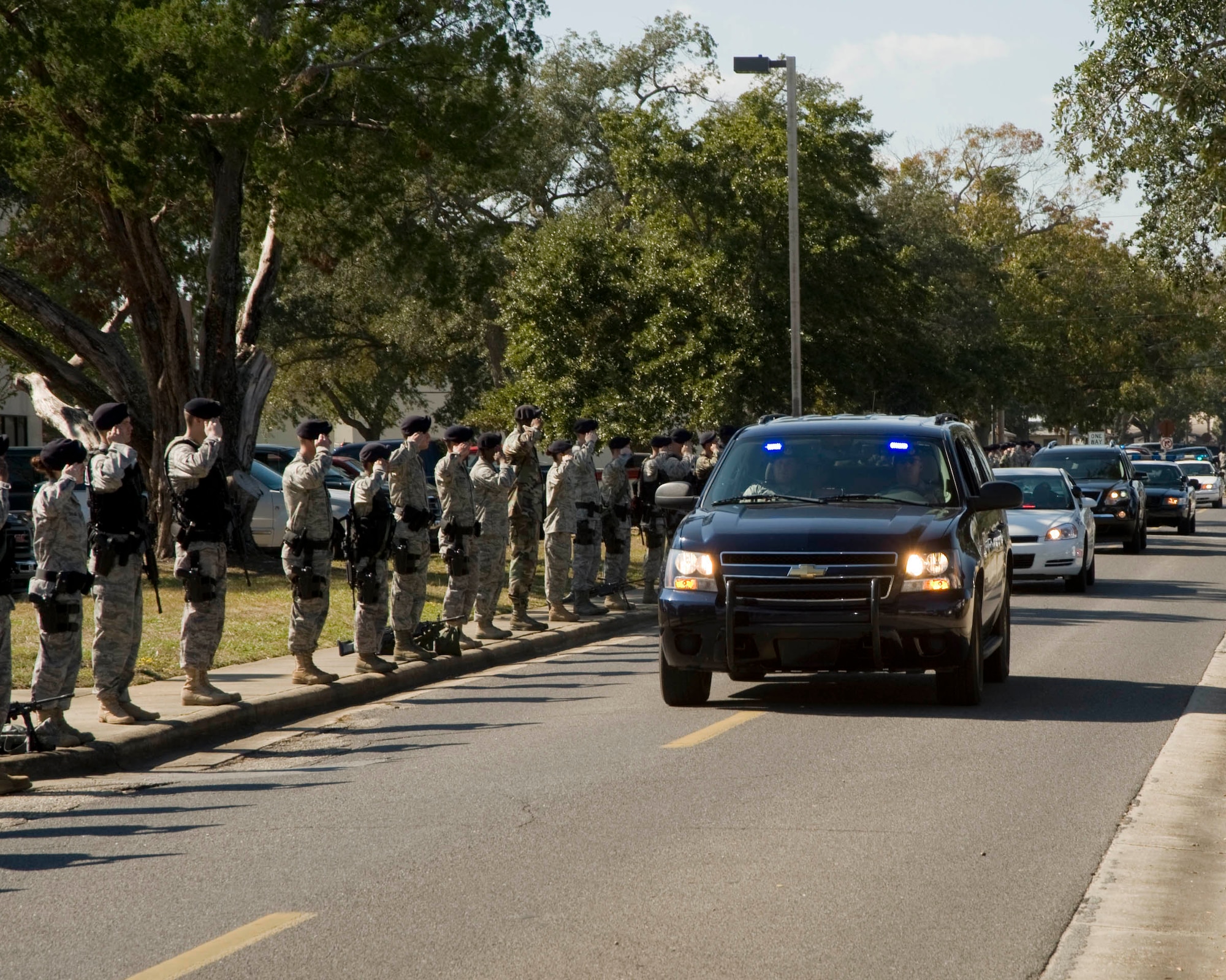 EGLIN AIR FORCE BASE, Fla. -- A line of 96th Security Forces Airmen and police cars from the local communities welcome Staff Sgt. Nick Bradley home.  Sergeant Bradley, assigned to the SF Squadron, was seriously injured when an improvised explosive device exploded near his vehicle as he was serving with a convoy traveling in Afghanistan. (USAF photo/Craig McDonnell)
