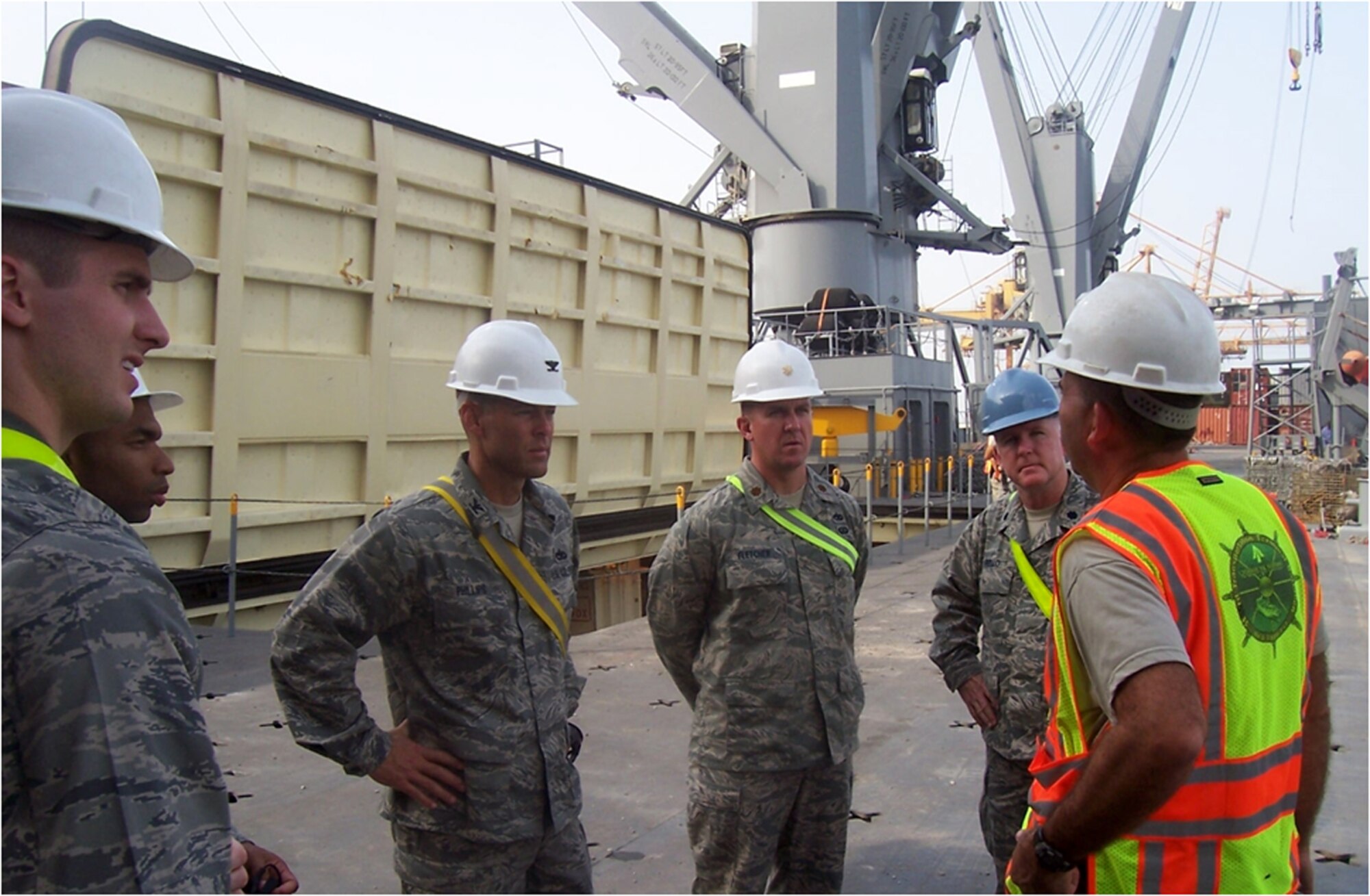 SOUTHWEST ASIA -- Maj.Joe Wool, Vessel supervisor, briefs Logistics Officer Association members from the 386th Air Expeditionary Wing on the ongoing ship download operations of the U.S. Naval Ship Soderman during a recent professional development tour. LOA members were briefed on aspects of vehicle staging  and transportation during the tour, as well as other details of the work that goes into supplying front-line war fighters in the War on Terror.