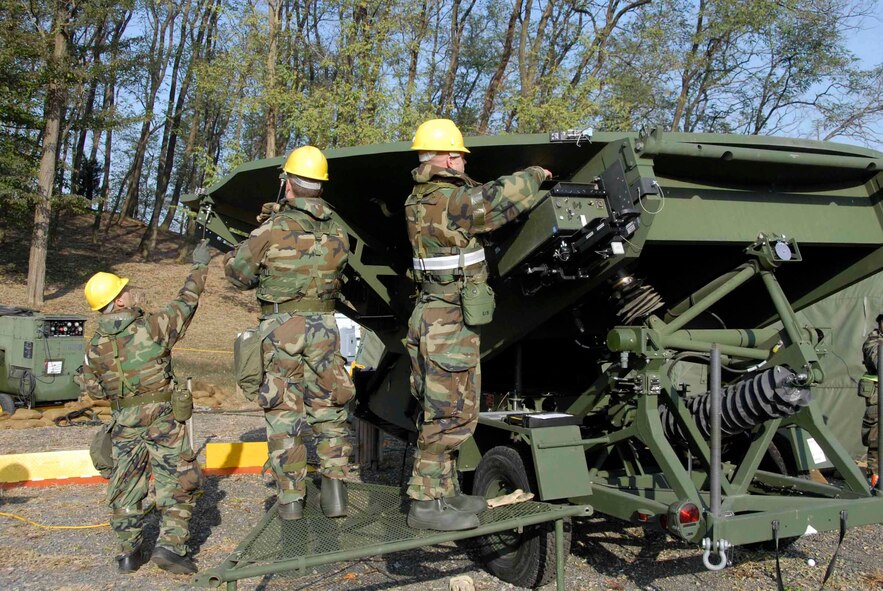 OSAN AIR BASE, Republic of Korea -- Members of the 607th Support Group Satellite Communications team practice a unique capability that allows Osan computers and telephone traffic to be routed up to a satellite and then on to its destination, instead of "flowing" through cables in the ground. Establishing back-up systems to link normal communications networks is critical should normal communications systems fail during a contingency. (U.S. Air Force photo/Staff Sgt. Lakisha Croley)