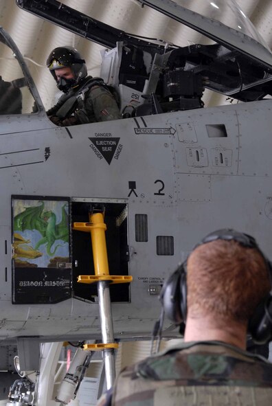OSAN AIR BASE, Republic of Korea -- Capt. Abram Burk, an A-10 pilot and Staff Sgt. George Pastere, 25th Aircraft Maintenance Unit crew chief complete a pre-flight inspection during Exercise Beverly Bulldog 08-04 Nov. 6. The exercise tests Team Osan’s ability to transition from peacetime to wartime operations, execution of the mission in a war time environment, and response time to major accident and natural disasters. (U.S. Air Force/Staff Sgt. Lakisha Croley)