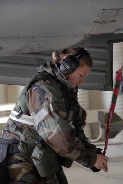 OSAN AIR BASE, Republic of Korea -- Staff Sgt. Shasta Eichler, 25th Aircraft Maintenance Unit weapons load team member, performs pre-flight checks on an A-10 Thunderbolt during Exercise Beverly Bulldog 08-04 Nov. 6. The week-long exercise tests Team Osan’s readiness and ability to execute combat operations receive follow-on forces and defend the base from attack. (U.S. Air Force/Staff Sgt. Lakisha Croley)