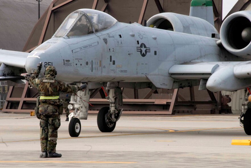 OSAN AIR BASE, Republic of Korea -- Staff Sgt. George Pastere, 25th Aircraft Maintenance Unit crew chief, marshals out an A-10 Thunderbolt during Exercise Beverly Bulldog 08-04 Nov. 6. The week-long exercise tests Team Osan’s readiness and ability to execute combat operations receive follow-on forces and defend the base from attack. (U.S. Air Force/Staff Sgt. Lakisha Croley)