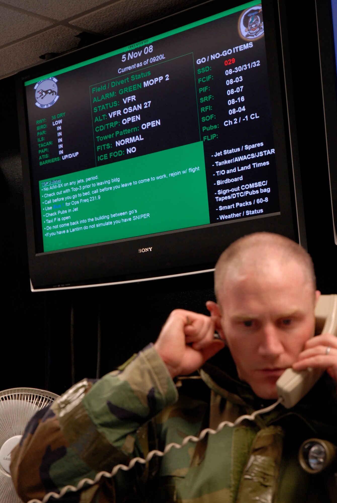 Capt. Patrick Pierson blocks out the noise of the co-located operations desk for the fighter squadrons at Kunsan Air Base, Republic of Korea during the Peninsula-Wide Operational Readiness Exercise, Nov. 5, 2008. Kunsan is participating in the PENORE as a test of its wartime capabilities and response actions (U.S. Air Force Photo by SSgt Jason Colbert)