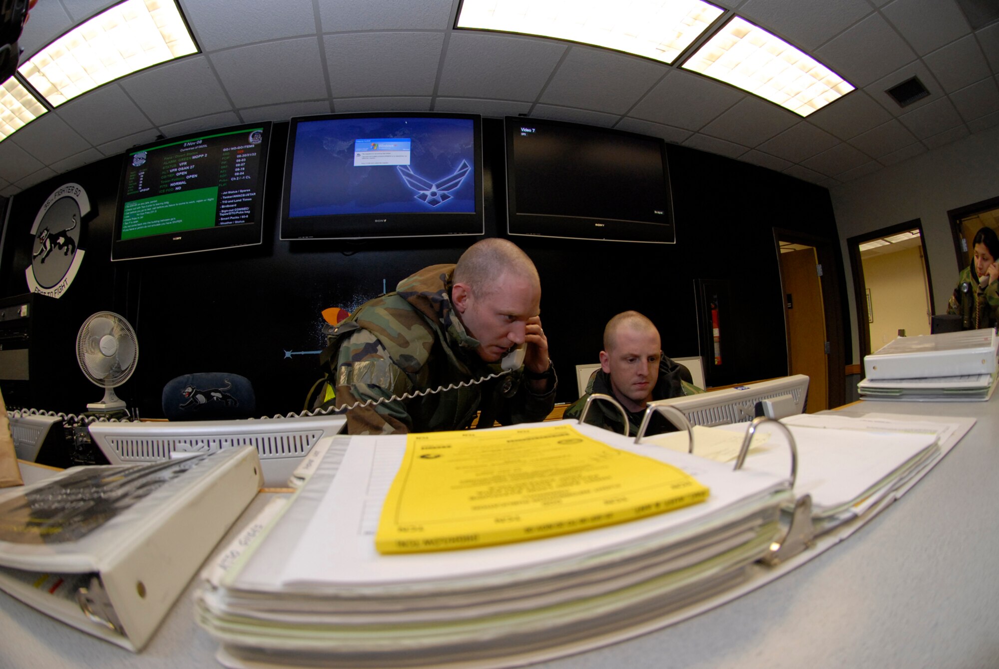 Capt. Patrick Pierson and Capt. Robert Speer coordinate aircraft flying missions at Kunsan Air Base, Republic of Korea during the Peninsula-Wide Operational Readiness Exercise, Nov. 5, 2008. Kunsan is participating in the PENORE as a test of its wartime capabilities and response actions (U.S. Air Force Photo by SSgt Jason Colbert)