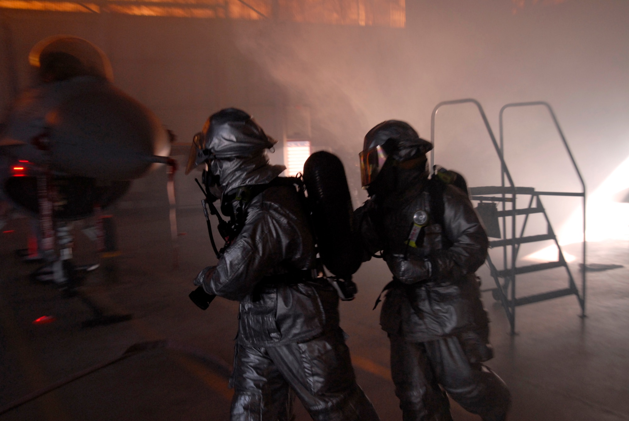 8th Civil Engineer Squadron fire fighters look for stranded and injured Airmen while fighting a simulated fire at Kunsan Air Base, Republic of Korea during the Peninsula-Wide Operational Readiness Exercise, Nov. 4, 2008. Kunsan is participating in the PENORE as a test of its wartime capabilities and response actions (U.S. Air Force Photo by SSgt Jason Colbert/RELEASED by SSgt Trevor Tiernan)