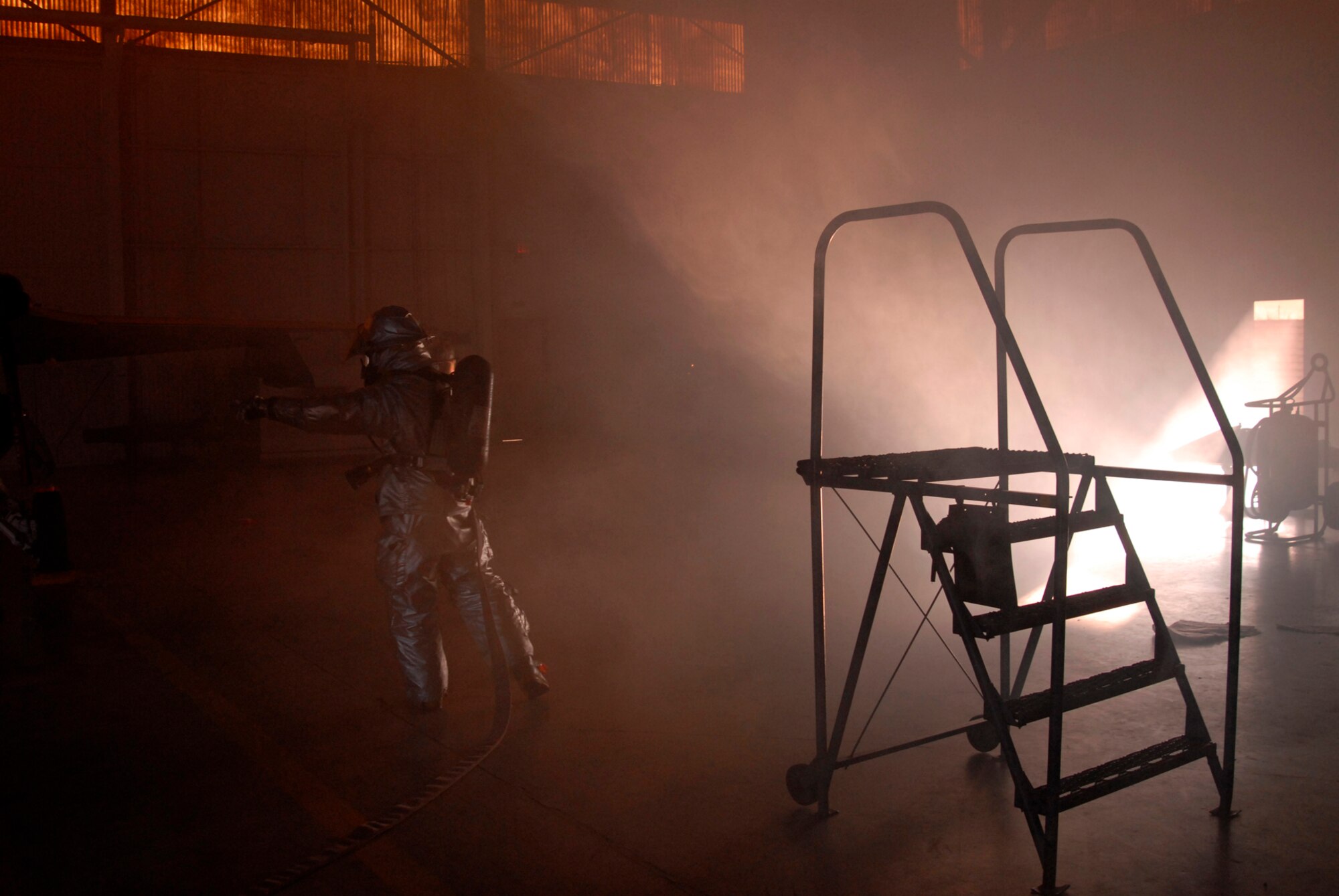 An 8th Civil Engineer Squadron fire fighter fights a simulated fire at Kunsan Air Base, Republic of Korea during the Peninsula-Wide Operational Readiness Exercise, Nov. 4, 2008. Kunsan is participating in the PENORE as a test of its wartime capabilities and response actions (U.S. Air Force Photo by SSgt Jason Colbert/RELEASED by SSgt Trevor Tiernan)