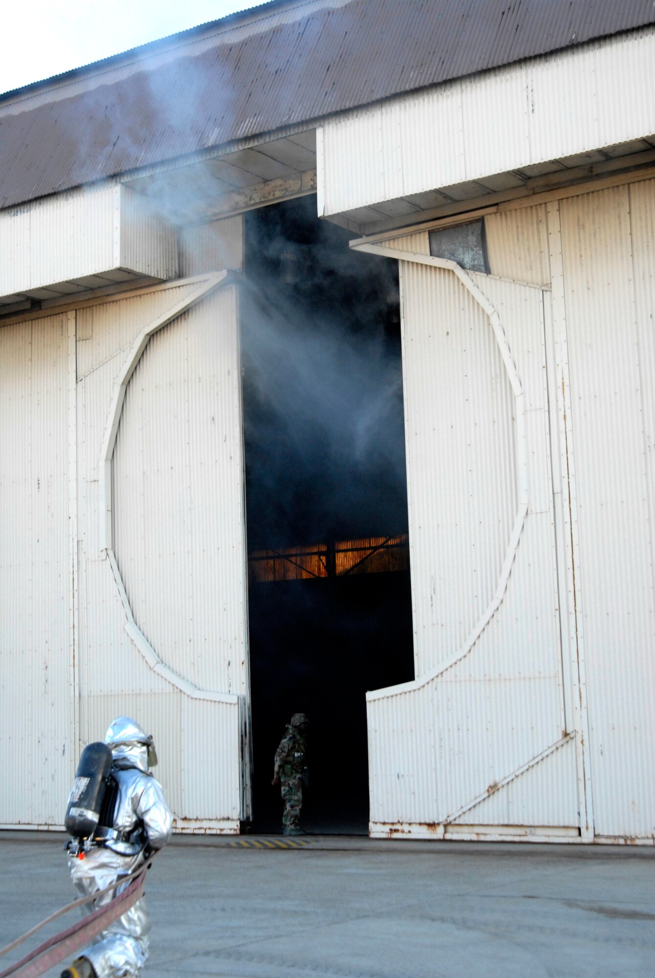 8th Civil Engineer Squadron fire fighters rush in to fight a fire at Kunsan Air Base, Republic of Korea during the Peninsula-Wide Operational Readiness Exercise, Nov. 4, 2008. Kunsan is participating in the PENORE as a test of its wartime capabilities and response actions (U.S. Air Force Photo by SSgt Jason Colbert/RELEASED by SSgt Trevor Tiernan)
