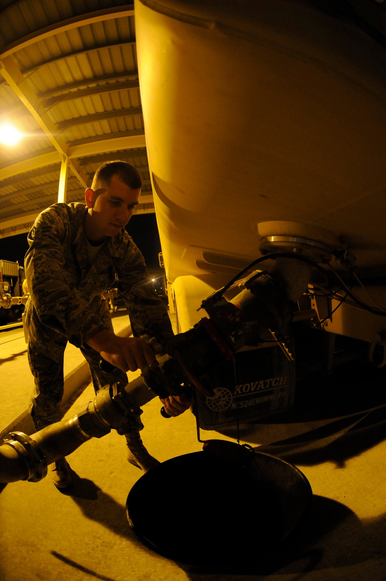 Airman 1st Class Deron Hix, fuels apprentice assigned to the 379th Expeditionary Logistics Readiness Squadron, uses a pantograph extension to fill an R-11 refueling truck so it can refuel aircraft Nov. 5, at an undisclosed air base in Southwest Asia. These 379th ELRS members fuel the fight by transferring approximately one million gallons of jet fuel per day, keeping all aircraft fueled and prepared for flight to support the Global War on Terrorism. Airman Hix, a native of Indianapolis, Ind., is deployed from Moody Air Force Base, Ga., in support of Operations Iraqi and Enduring Freedom and Joint Task Force-Horn of Africa. (U.S. Air Force photo by Staff Sgt. Darnell T. Cannady/Released)