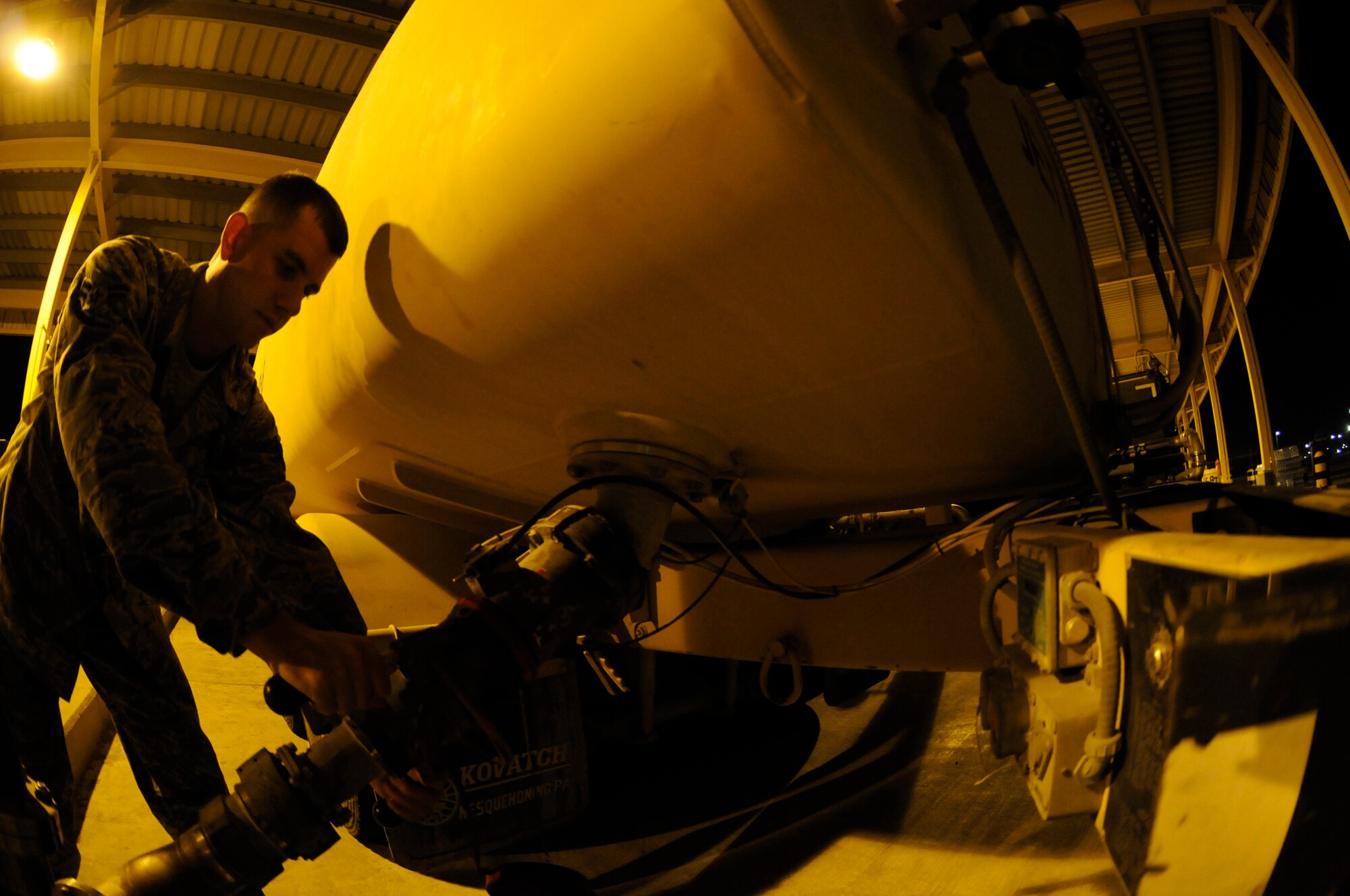 Airman 1st Class Deron Hix, fuels apprentice assigned to the 379th Expeditionary Logistics Readiness Squadron, uses a pantograph extension to fill an R-11 refueling truck so it can refuel aircraft Nov. 5, at an undisclosed air base in Southwest Asia. These 379th ELRS members fuel the fight by transferring approximately one million gallons of jet fuel per day, keeping all aircraft fueled and prepared for flight to support the Global War on Terrorism. Airman Hix, a native of Indianapolis, Ind., is deployed from Moody Air Force Base, Ga., in support of Operations Iraqi and Enduring Freedom and Joint Task Force-Horn of Africa. (U.S. Air Force photo by Staff Sgt. Darnell T. Cannady/Released)