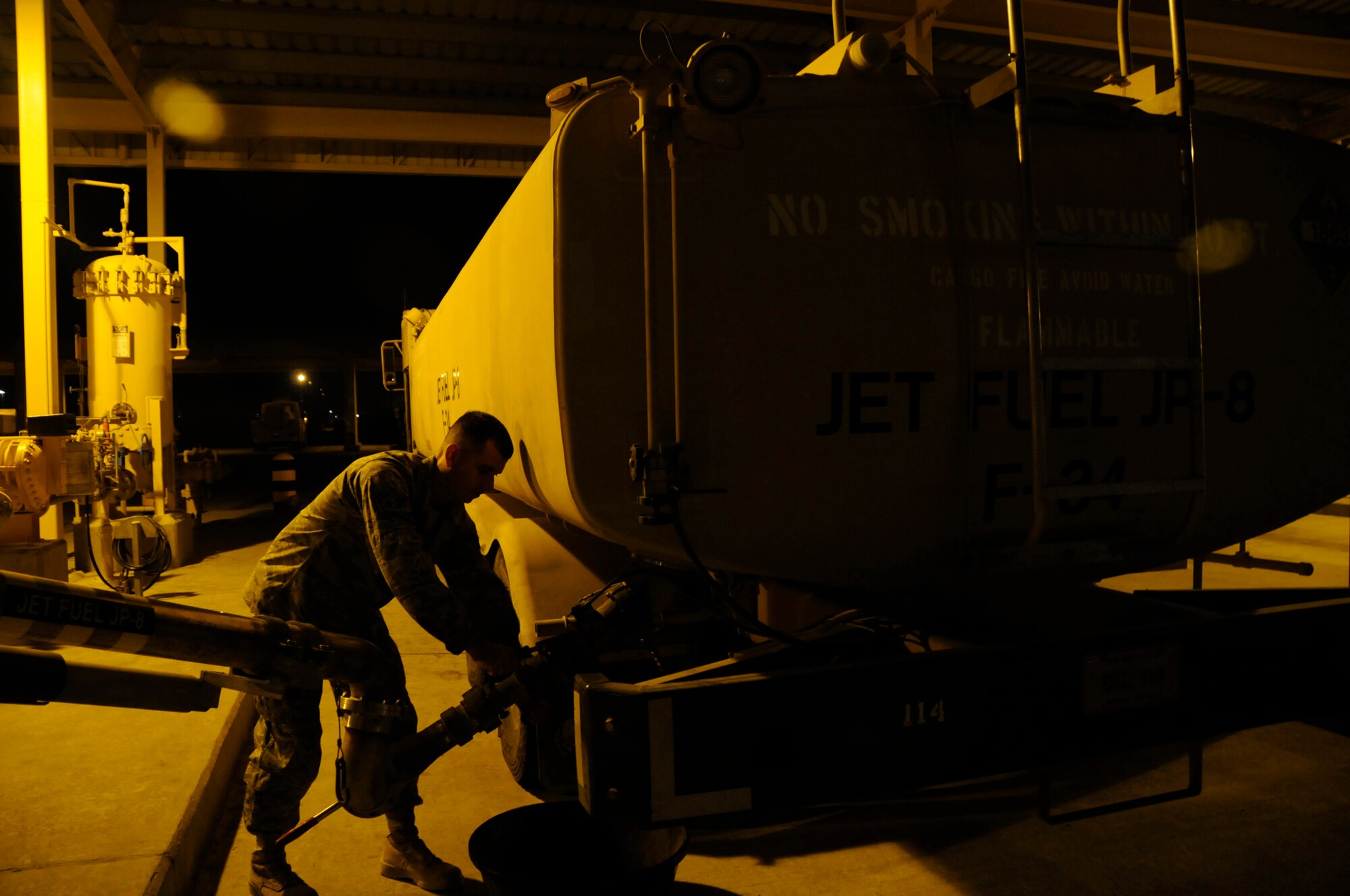 Airman 1st Class Deron Hix, fuels apprentice assigned to the 379th Expeditionary Logistics Readiness Squadron, uses a pantograph extension to fill an R-11 refueling truck so it can refuel aircraft Nov. 5, at an undisclosed air base in Southwest Asia. These 379th ELRS members fuel the fight by transferring approximately one million gallons of jet fuel per day, keeping all aircraft fueled and prepared for flight to support the Global War on Terrorism. Airman Hix, a native of Indianapolis, Ind., is deployed from Moody Air Force Base, Ga., in support of Operations Iraqi and Enduring Freedom and Joint Task Force-Horn of Africa. (U.S. Air Force photo by Staff Sgt. Darnell T. Cannady/Released)