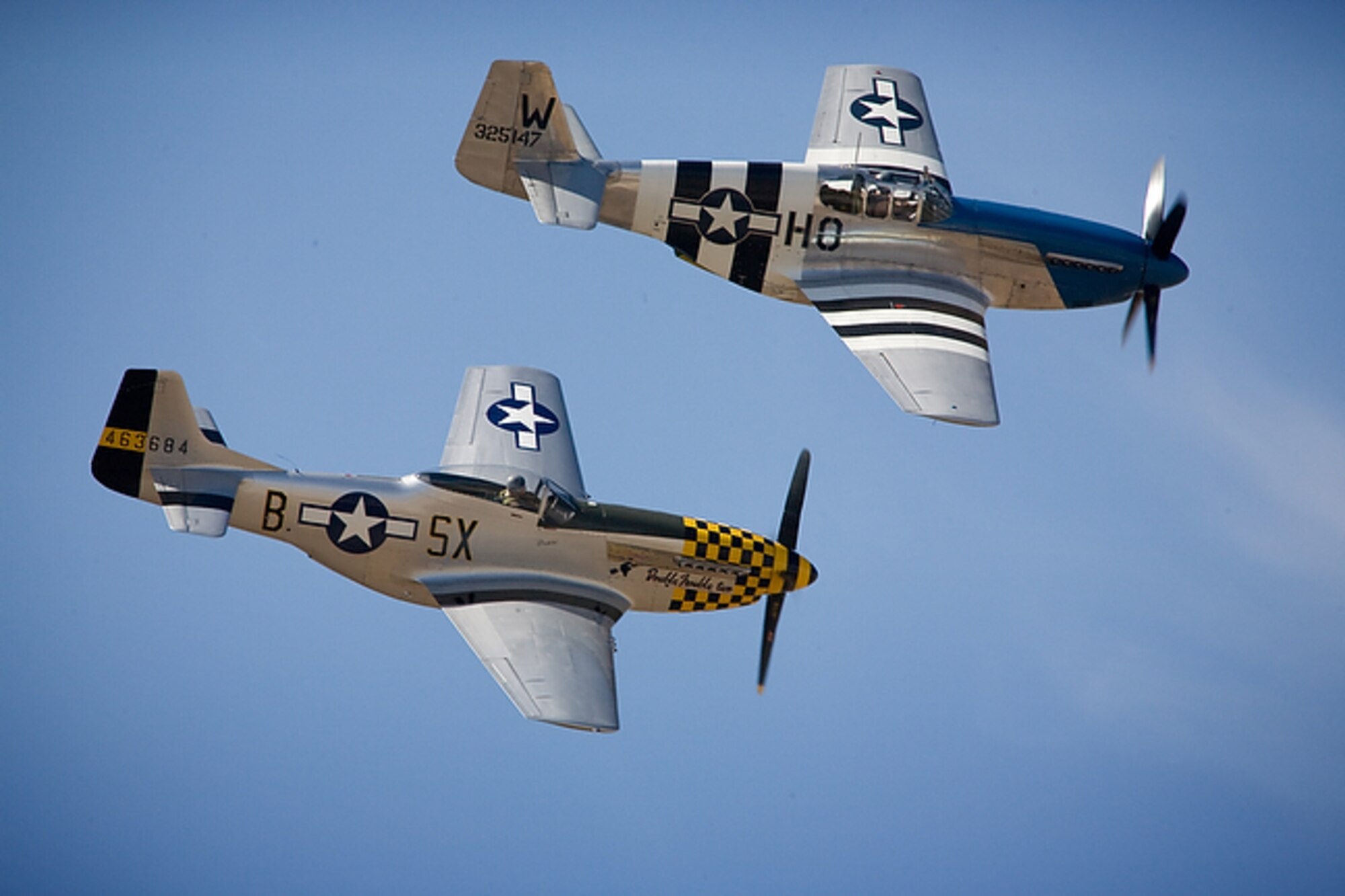Two P-51 Mustangs make a pass over AirFest 2008 at Lackland Air Force Base's Kelly Field Annex, Texas on Oct. 31, 2008. This image is copyrighted and is the property of Lance Cheung and is available only to members of the armed forces and military organizations. (Courtesy photo/Lance Cheung)