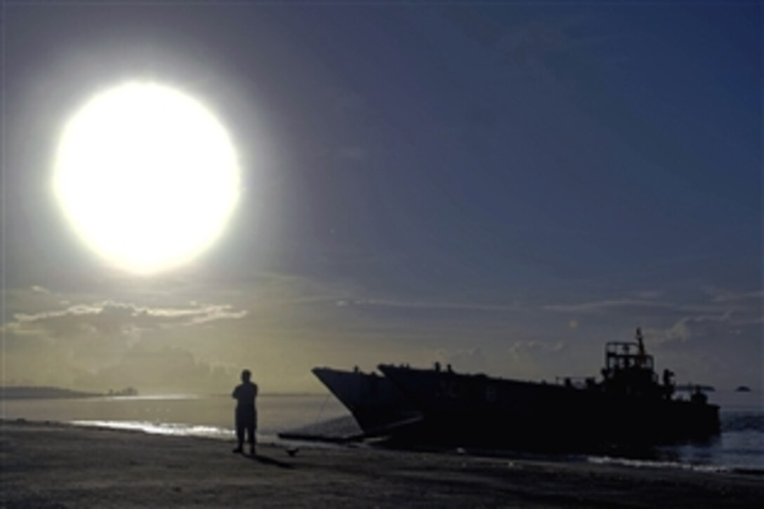 A U.S. Navy sailor waits to transport a team of medics to the USS Kearsarge on a landing craft mechanized amphibious unit in support of Operation Continuing Promise 2008, in Trinidad and Tobago, Nov. 4, 2008. 