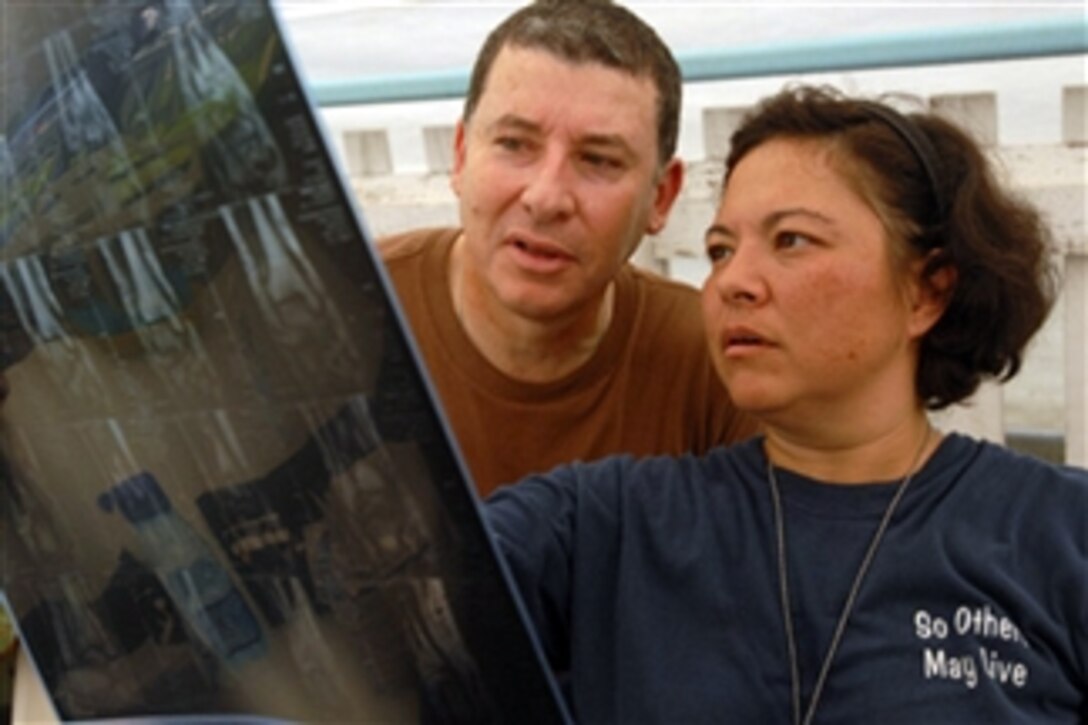 U.S. Air Force Maj. Ricardo Rodrigues and Coast Guard Lt. Cmdr. Kimberly Roman, both embarked aboard the USS Kearsarge (LHD 3), examine a patient's x-ray at the Couva District Health Facility during a medical assistance mission in Couva, Trinidad and Tobago, on Nov. 3, 2008.  The Kearsarge is deployed in support of the Caribbean phase of the humanitarian and civic assistance mission Continuing Promise 2008, an equal-partnership mission involving the United States, Canada, the Netherlands, Brazil, Nicaragua, Colombia, Dominican Republic, Trinidad and Tobago and Guyana.  