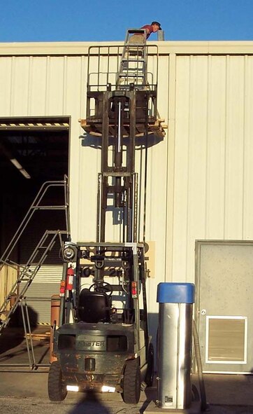 DYESS AIR FORCE BASE, Texas -- A worker jimmy-rigged this forklift-ladder combination to reach the roof of the building he was working on Oct. 27. This unsafe act could have resulted in an injury or worse, according to safety officials. (U.S. Air Force photo)