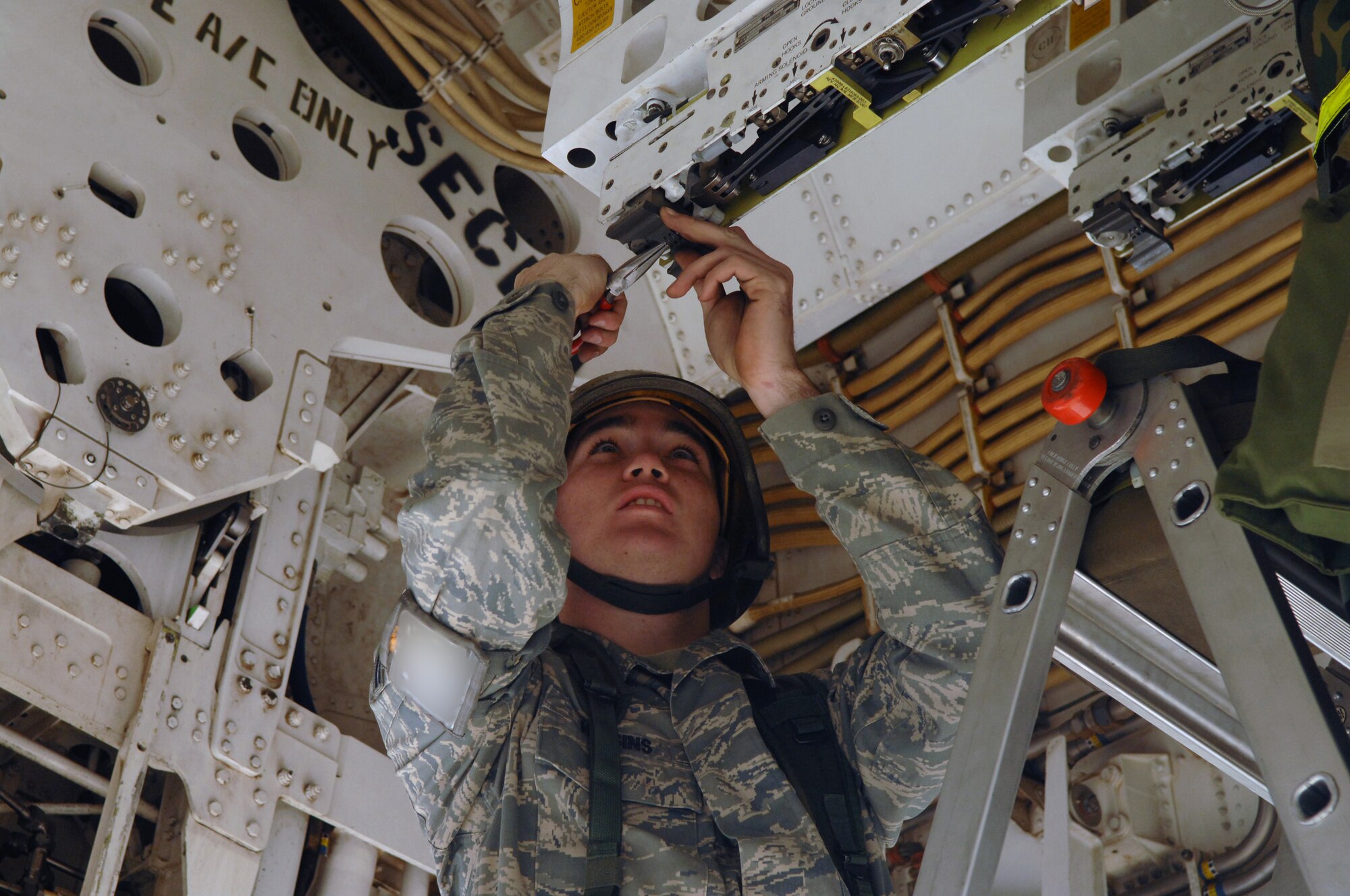 DYESS AIR FORCE BASE, Texas – Airman 1st Class Michael Higgins, 7th Munitions Squadron, works on putting an attachment under a B-1 plane, which buffers the bombs being loaded and helps it from swaying during an Operation Readiness Exercise here Nov. 7. The exercise times how well Airmen work together as a team and how fast they can get a plane ready for deployment.  This exercise will also help prepare Airmen for real world missions and the upcoming Operation Readiness Inspection when the base will be looked at on its effectiveness in performing a wartime, contingency, force sustainment and operational mission.  (U.S. Air Force photo/Staff Sgt Connor Estes)  