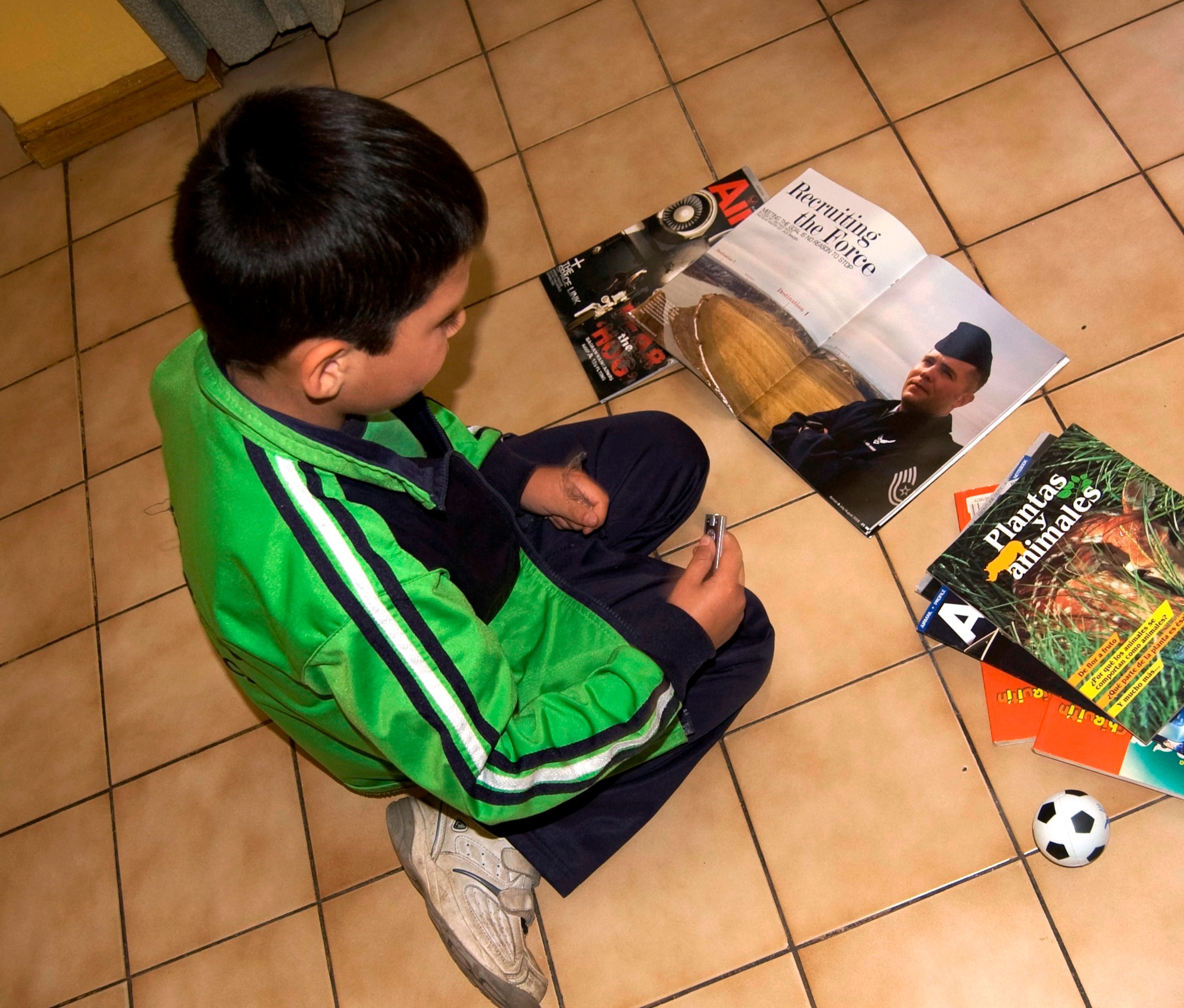 A Chilean boy looks at the U.S. Air Forces “Airmen Magazine” during a visit Oct. 29 by Airmen, a Soldier and U.S. civilian volunteers to the ALDEAS SOS orphanage in Santiago, Chile for a cultural exchange of food and camaraderie as part of Operation Southern Partner -- a Twelfth Air Force (Air Forces Southern) led event aimed at providing intensive, periodic subject-matter exchanges in the U.S. Southern Command area of focus. (Air Force photo\Master Sgt. Eric M. Grill)