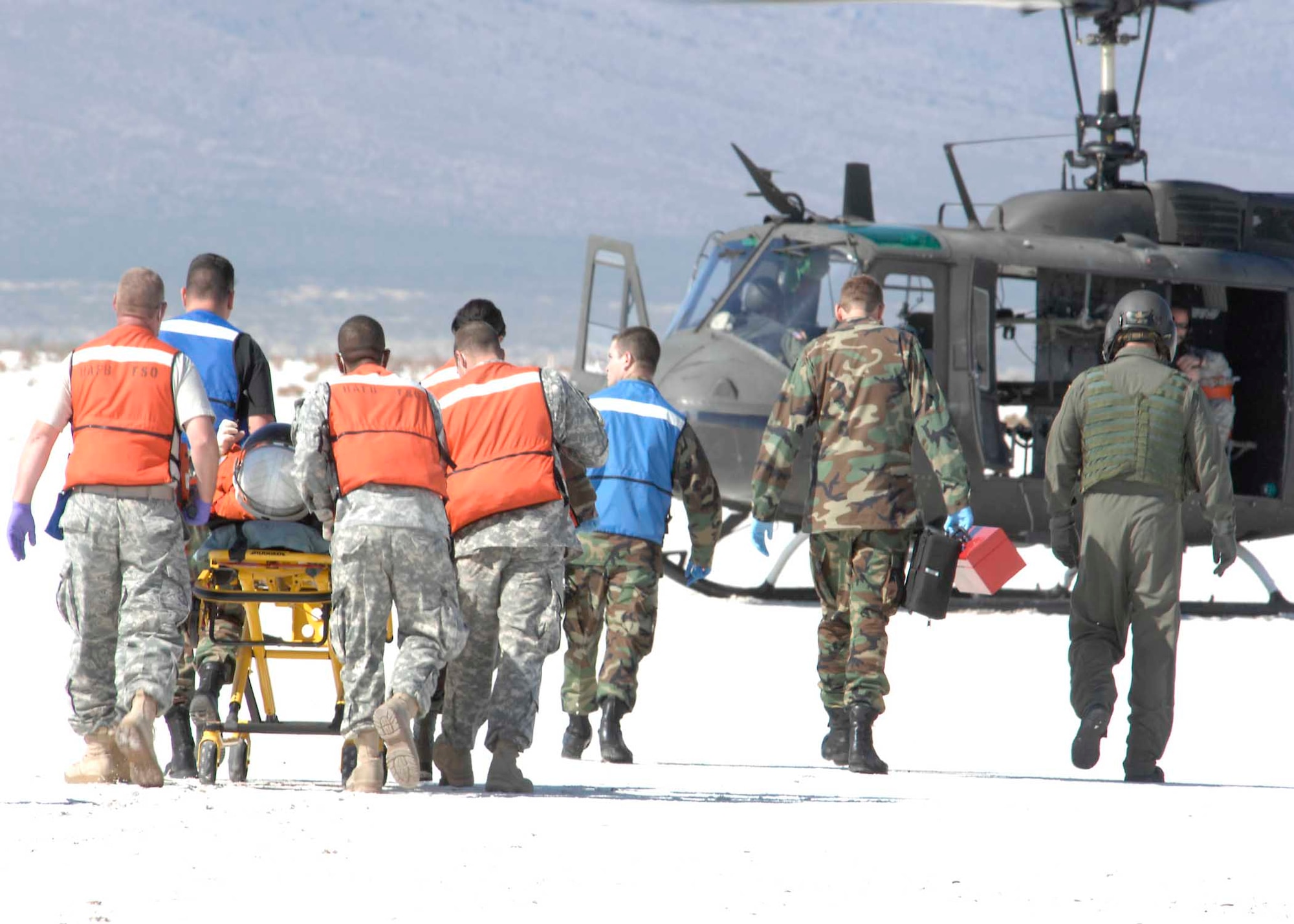 Holloman medical personnel prepare to evacuate a shuttle team member during a simulated shuttle landing exercise. Approximately 60 members from Holloman, White Sands Missile Range and the National Aeronautics and Space Administration (NASA) came together for a shuttle emergency landing exercise at the White Sands Space Harbor, Oct. 30. (U.S. Air Force photo/Airman 1st Class Rachel A. Kocin)