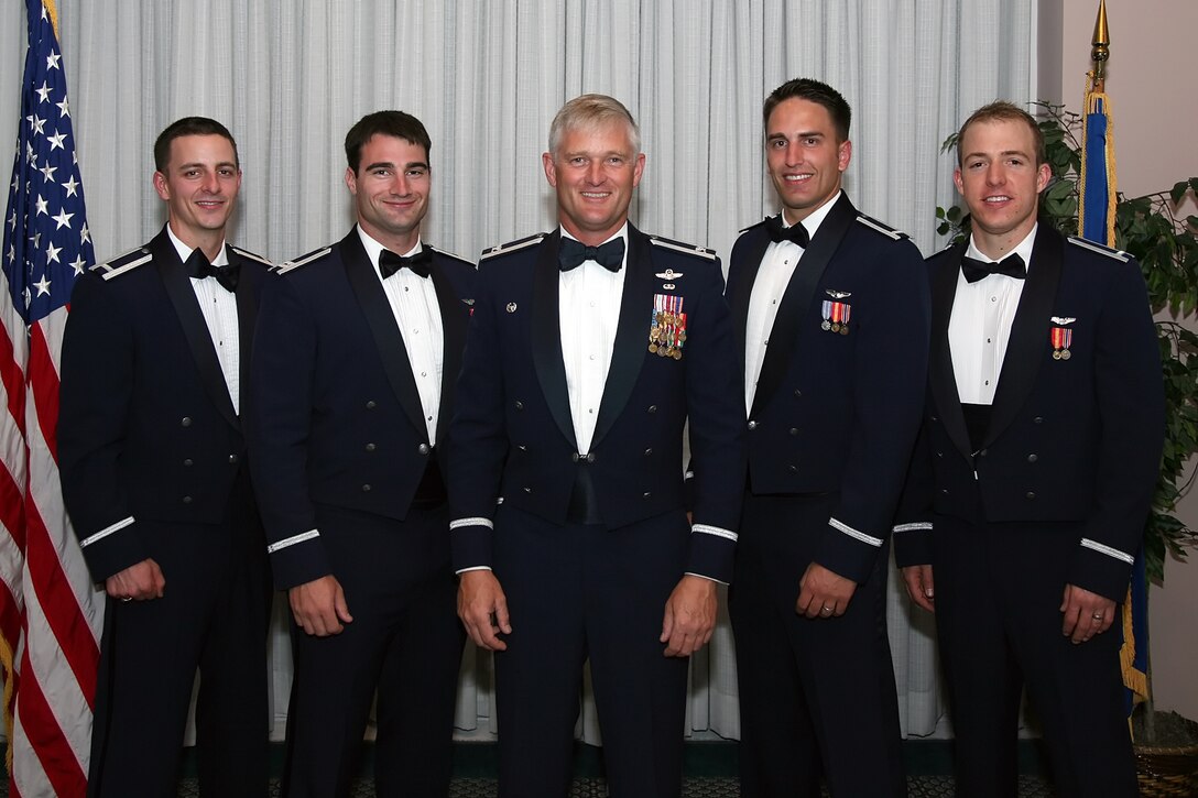 The first U.S. Air Force F-22 Raptor Basic Course class graduated Nov. 1 at the Tyndall Air Force Base Heritage Club. Col. William H. Mott (center), 325th Operations Group commander  stands with the four graduating student pilots, (left to right) 1st Lt. Daniel Dickinson, Capt. Marcus McGinn, 1st Lt. Ryan Shelhorse and 1st Lt. Austin B. Skelly. (U.S. Air Force photo by Staff Sgt. Vesta M. Anderson)