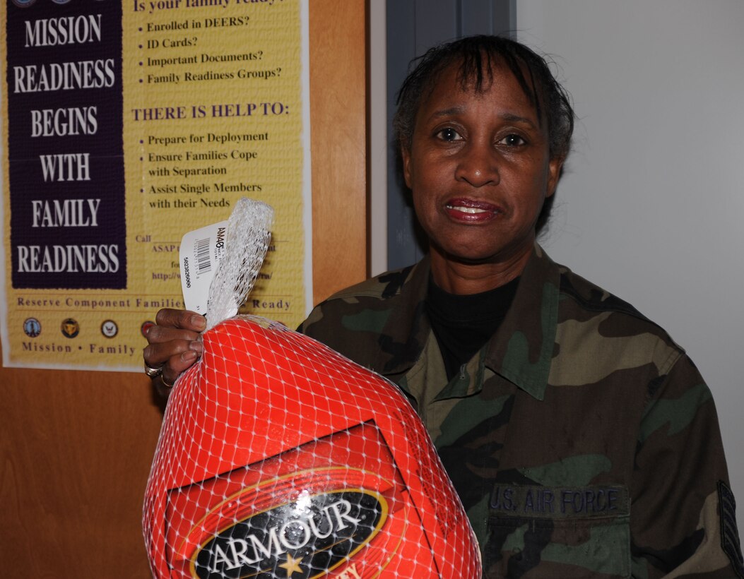 932nd Airlift Wing member Tech. Sgt. Adri Palmer, brings a turkey donation into the family readiness office in preparation for Thanksgiving.  She and others are helping to create baskets of food for fellow military members.  (U.S. Air Force/Maj. Stan Paregien)