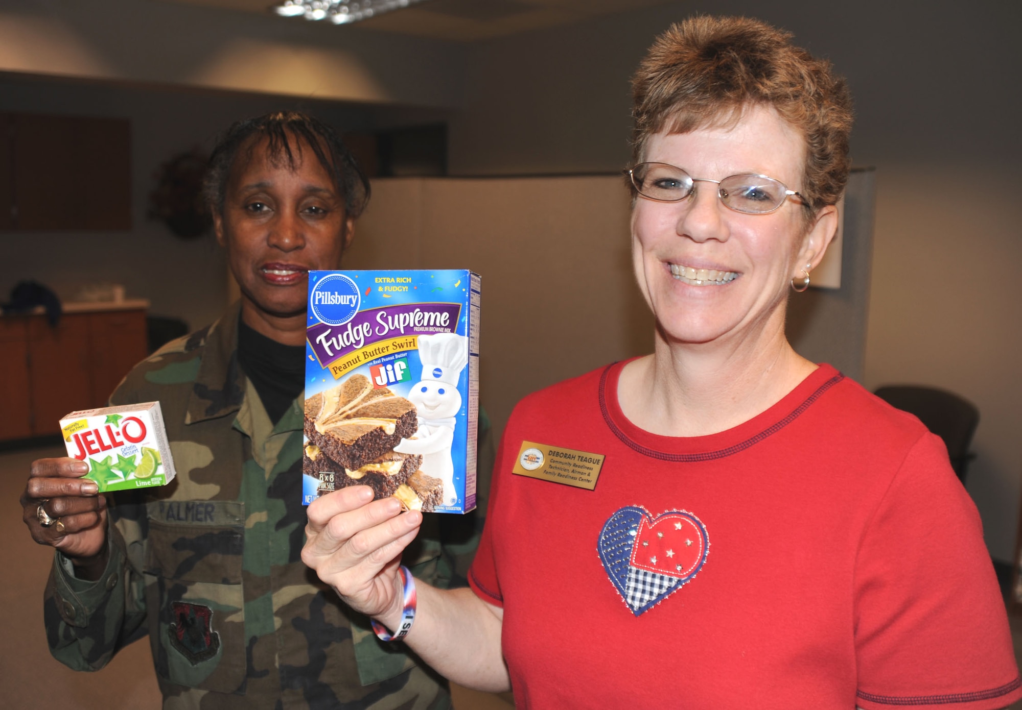932nd Airlift member Tech. Sgt. Adriane Palmer, brings jello to Deborah Teague in the family readiness office to help with Thanksgiving. She and others are helping to create baskets of food for fellow military members.  You can get involved by talking to them on the drill weekend.  (U.S. Air Force/Maj. Stan Paregien) 