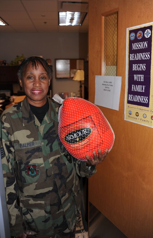932nd Airlift Wing's Tech. Sgt. Adriane Palmer reminds you that "Mission Readiness begins with Family Readiness" as she helps load turkeys for the holidays.  The donated turkeys and other food items will be used to help families and individuals in need this season.  (U.S. Air Force photo/Maj. Stan Paregien)