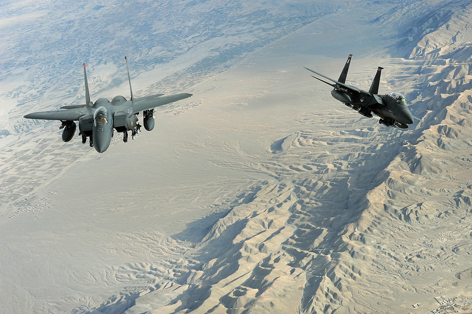 Two F-15E Strike eagles fly a mission over Afghanistan on Nov. 7. The aircraft uses two crew members, a pilot and a weapon systems officer. Previous models of the F-15 are assigned air-to-air roles; the "E" model is a dual-role fighter. It has the capability to fight its way to a target over long ranges, destroy enemy ground positions and fight its way out. (U.S. Air Force photo/Staff Sgt. Aaron Allmon)