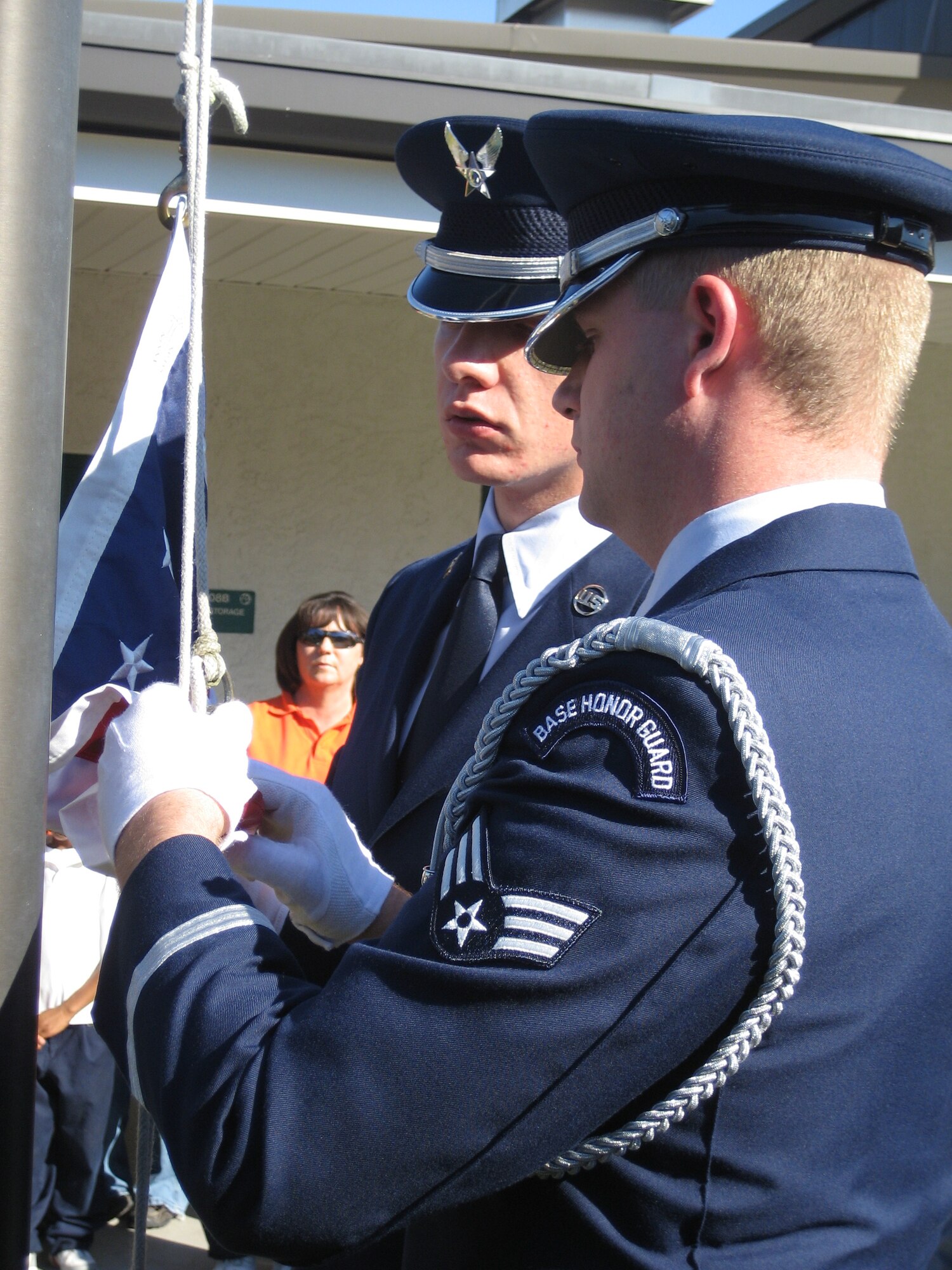 Two Tyndall Elite Honor Guard members, Senior Airmen Eric Graca (left) and Clinton Gibson (right), raise the American flag at Springfield Elementary today. The flag was donated to the school by the Ladies Auxiliary to the Veterans of Foreign Wars. (U.S. Air Force photo by Staff Sgt. Vesta M. Anderson)