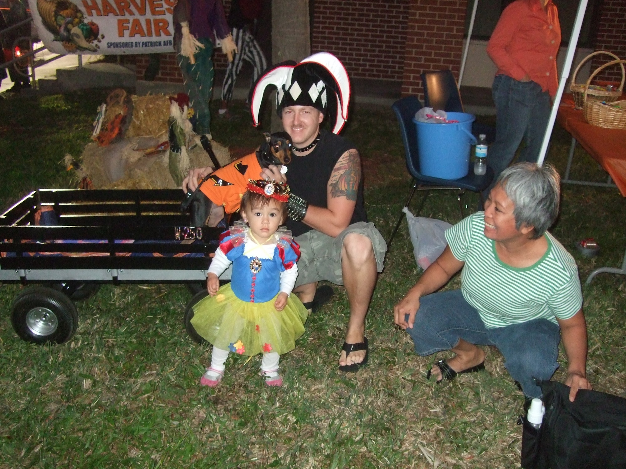 Katelyn Thomas is surprised by the camera as she enjoys the South Patrick Chapel's Harvest Fair Oct. 31 with her father, Staff Sgt. Bryan Thomas and her dog Rex. (U.S. Air Force photo by Staff Sgt. Maria Gonzales)