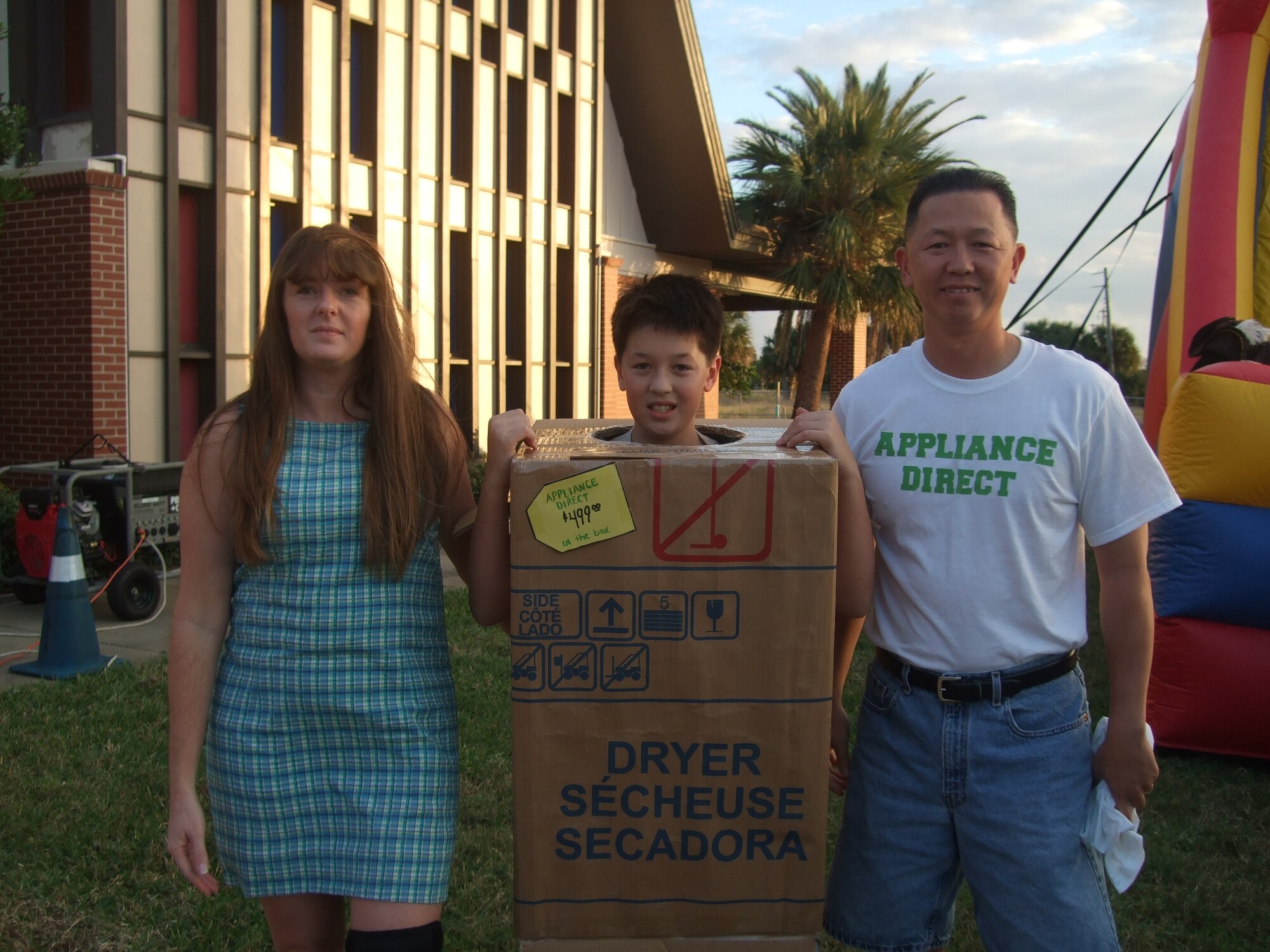 Master Sgt. Phuoc Phan together with his wife Shari and son Christian imitate a well-known local appliance selling team at the South Patrick Chapel's Harvest Fair Oct. 31. (U.S. Air Force photo by Staff Sgt. Maria Gonzales)