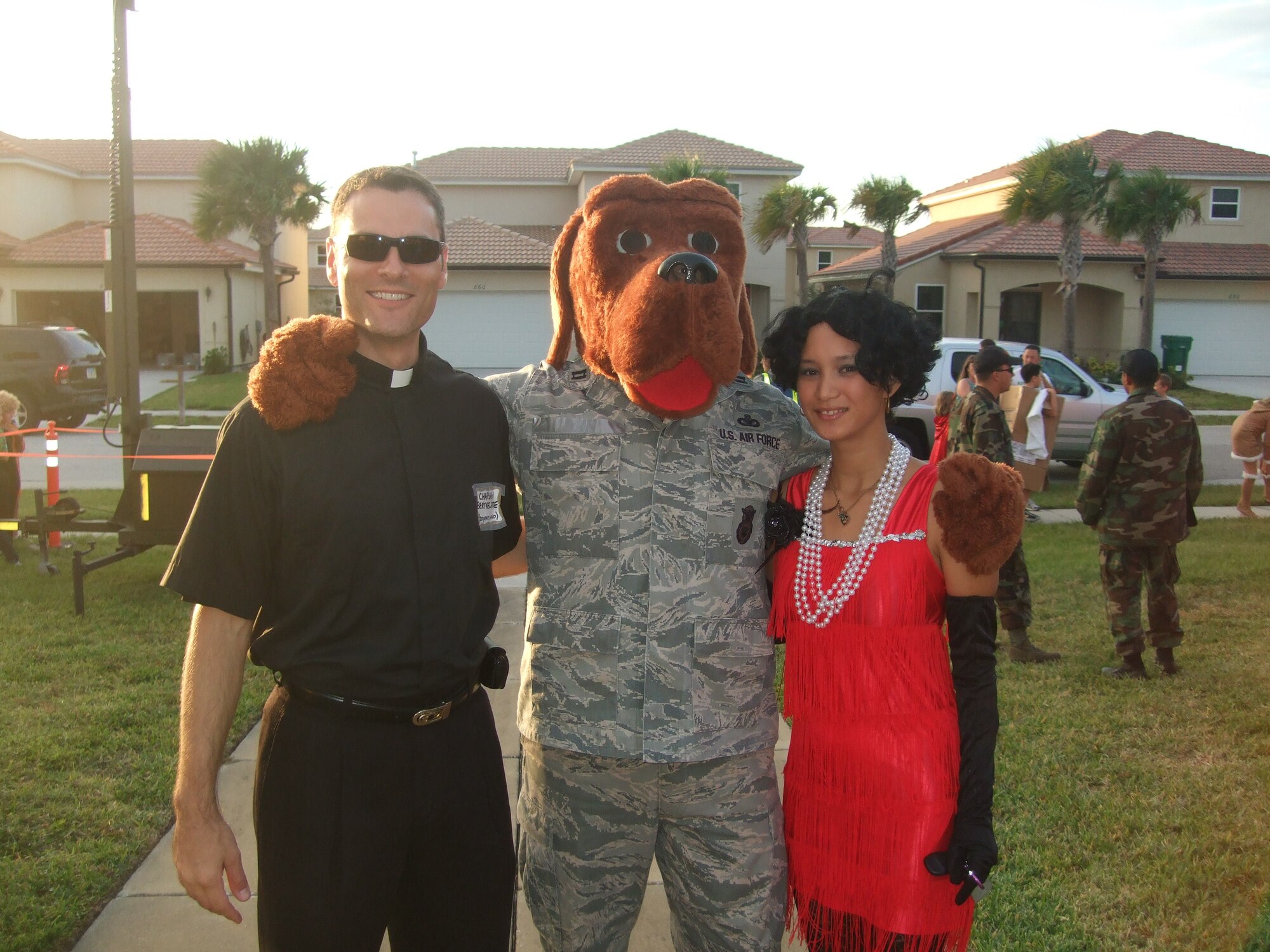 Chaplain Christopher La Pack, Capt. Sean Lovell, and Senior Airman Halena enjoy each other's company at the South Patrick Chapel's Harvest Festival Oct. 31. Guests were encouraged to wear costumes and the chapel provided activities for the children. (U.S. Air Force photo by Staff Sgt. Maria Gonzales)